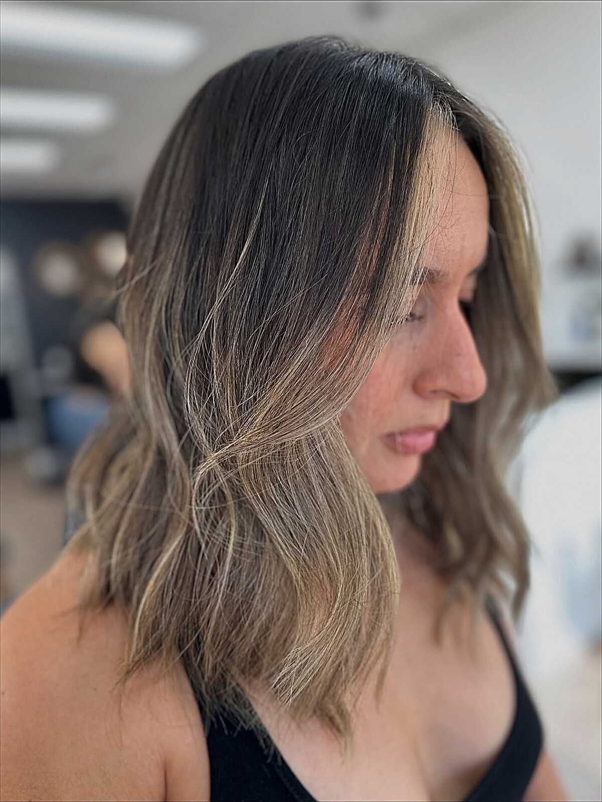 Honey blonde wavy lob with dark root melt