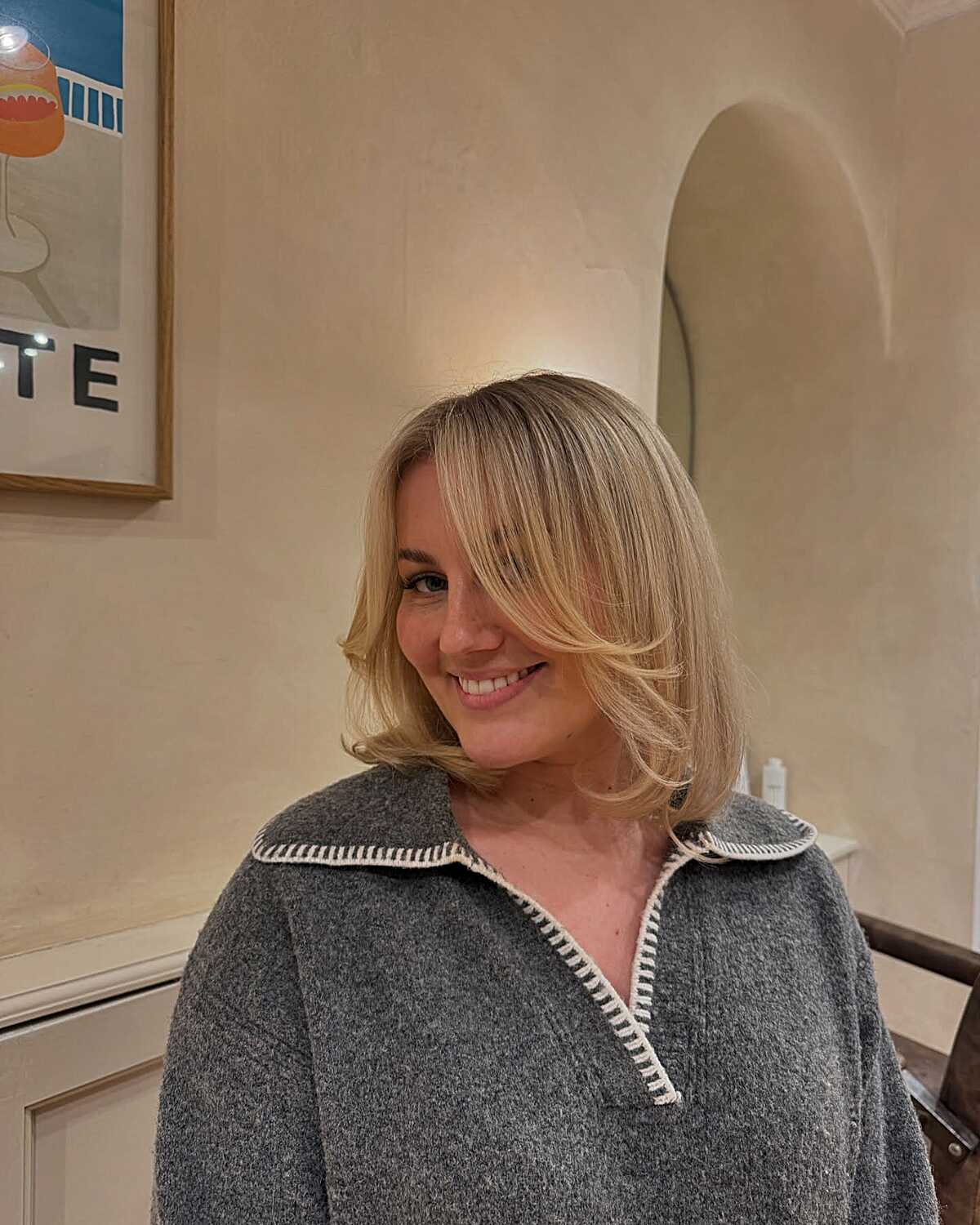 Blonde flipped lob with curtain bangs and volume