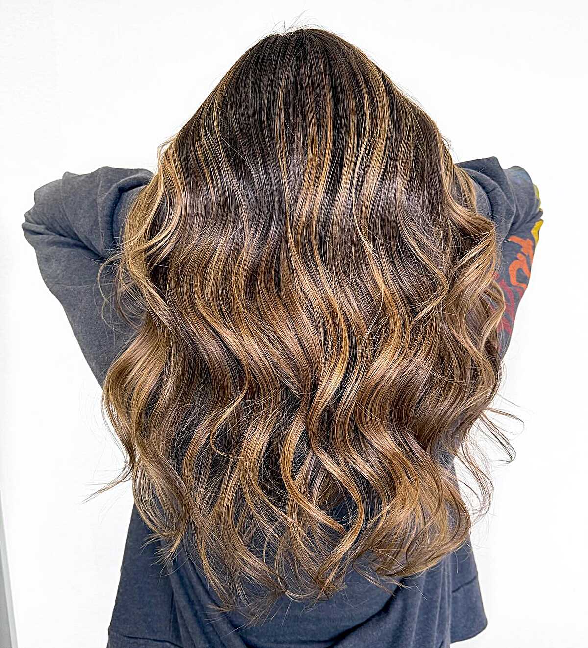 Chocolate brown hair with golden caramel balayage waves