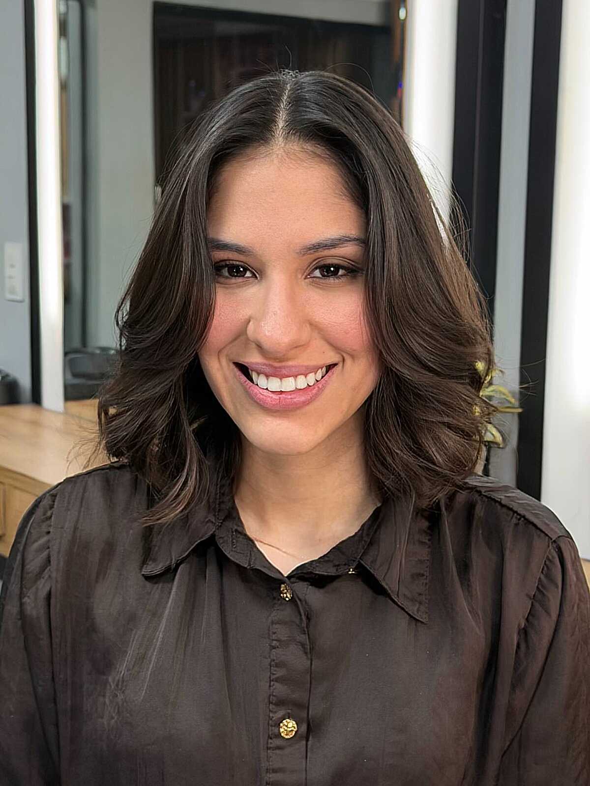 Brunette lob with bouncy soft waves and center part