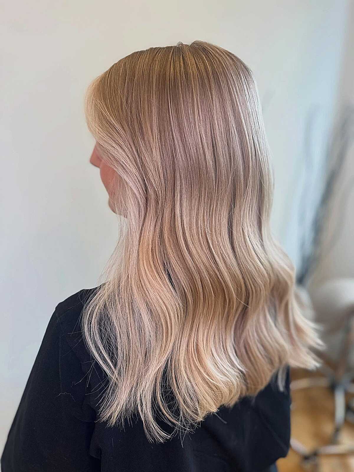 Medium-length peachy cream blonde balayage straight hair