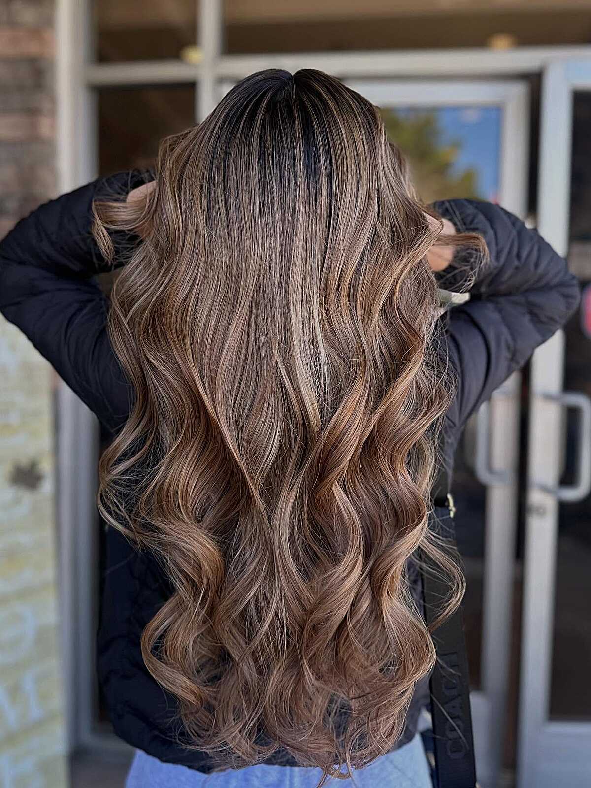 Long dark hair with toasted almond balayage and big waves