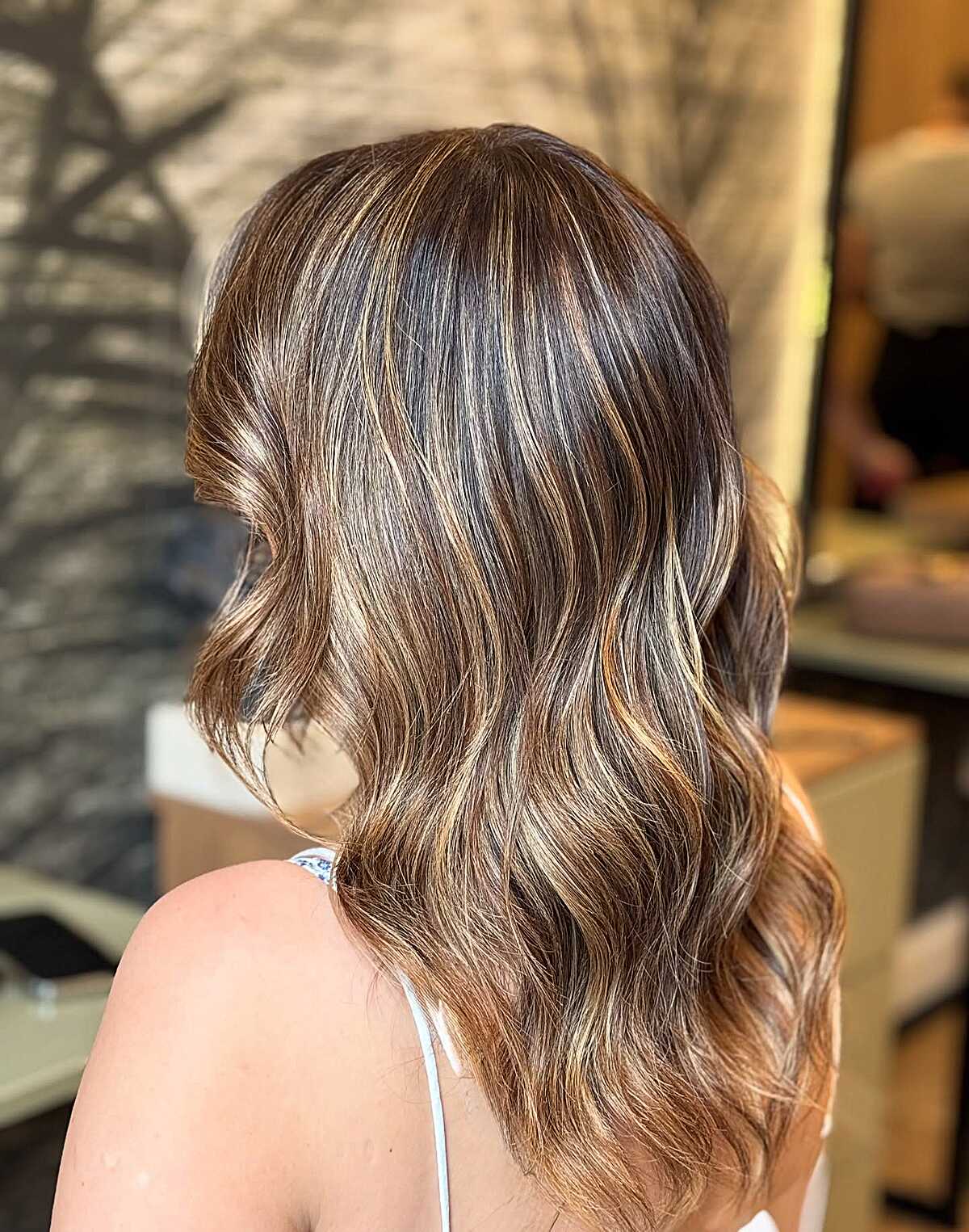 Medium brown balayage with honey highlights and soft waves
