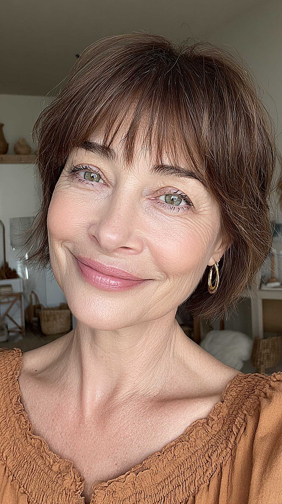 Brunette ear-length bob with wispy bangs and texture