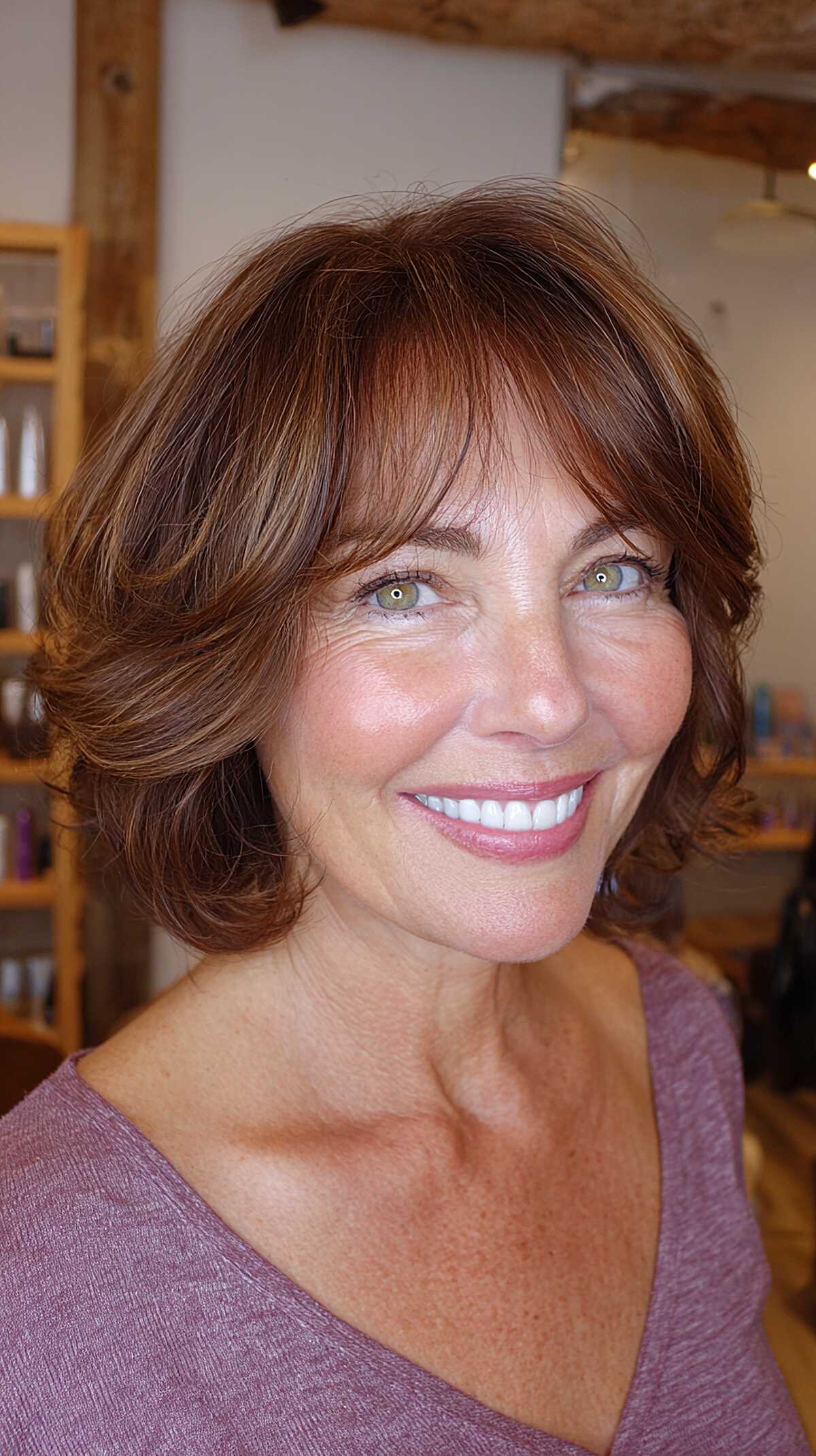 Chestnut layered bob with curtain bangs and flipped ends