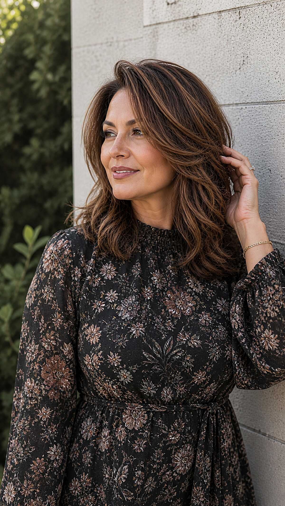Wavy chocolate brown layered hair with caramel highlights