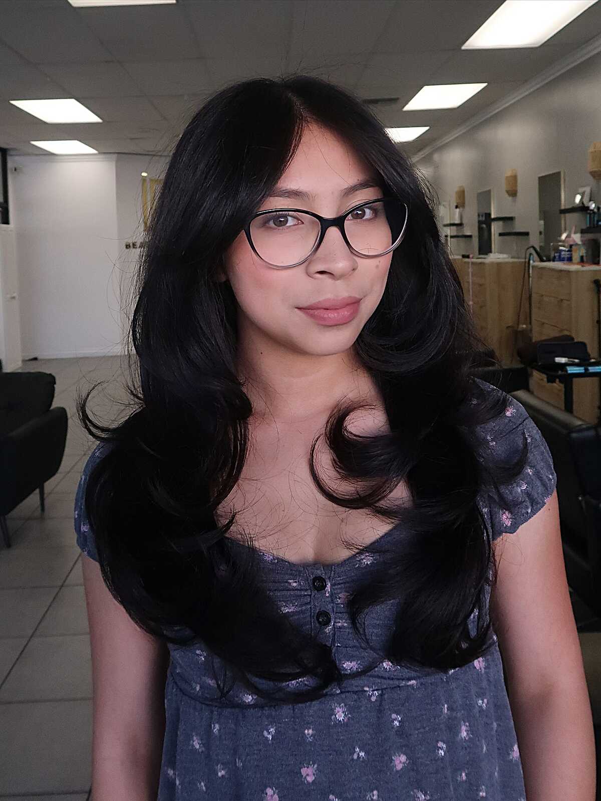 Black layered hair with curtain bangs and flipped ends