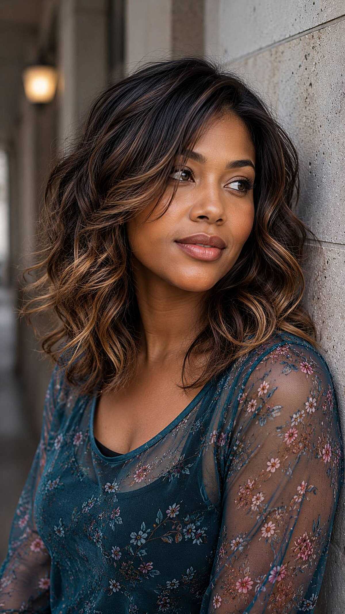 Dark espresso curly medium hair with caramel highlights