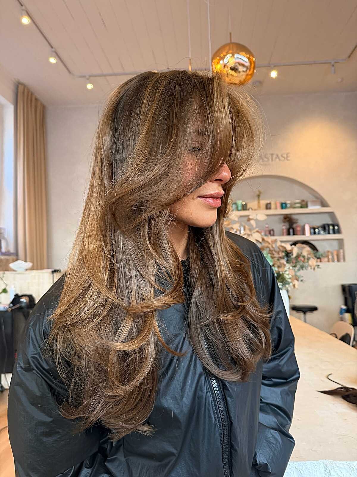 Honey bronde long layered blowout with curtain bangs
