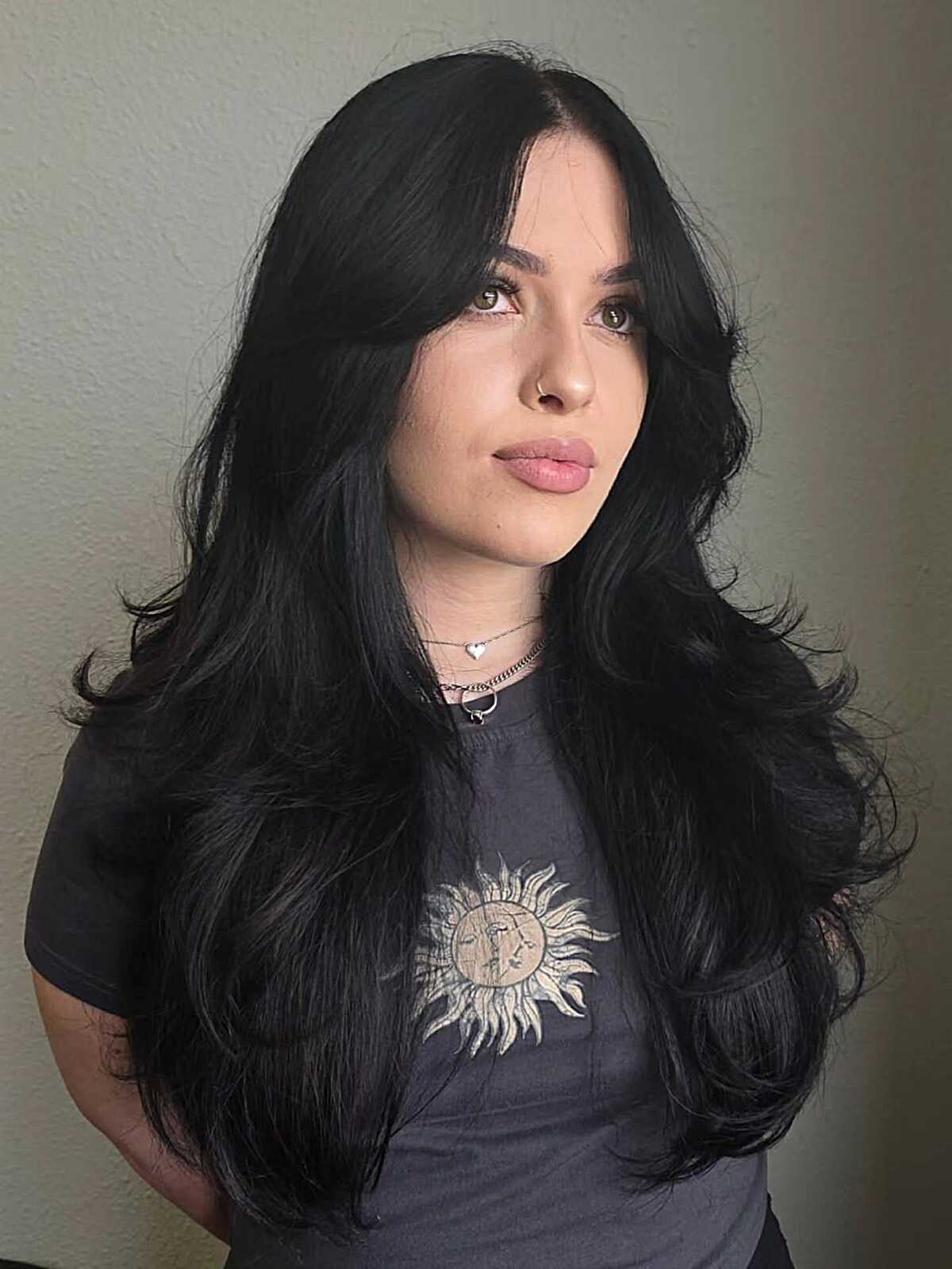 Long black wavy layers with side-swept curtain bangs