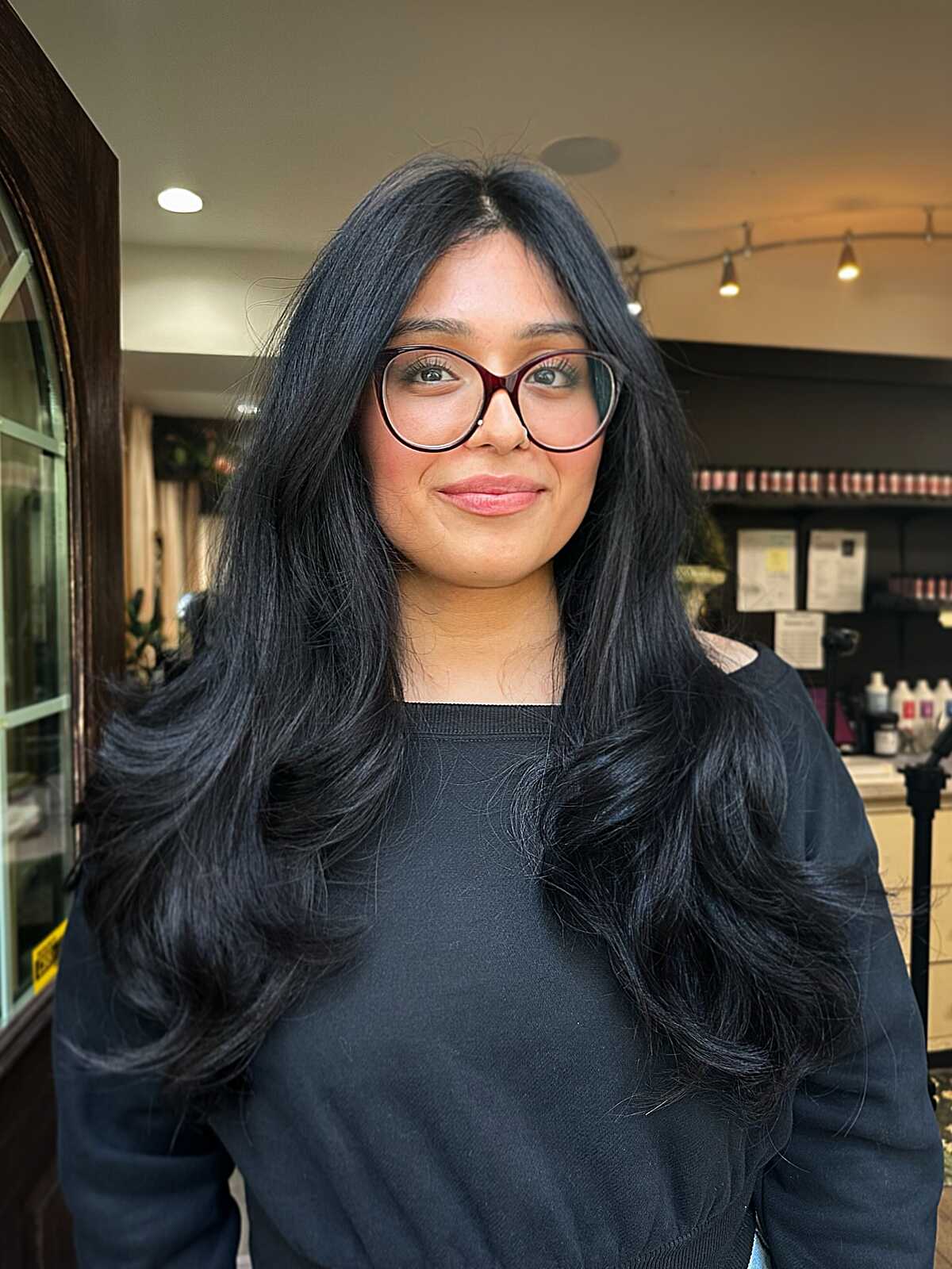 Jet black long wavy layers with wispy curtain bangs