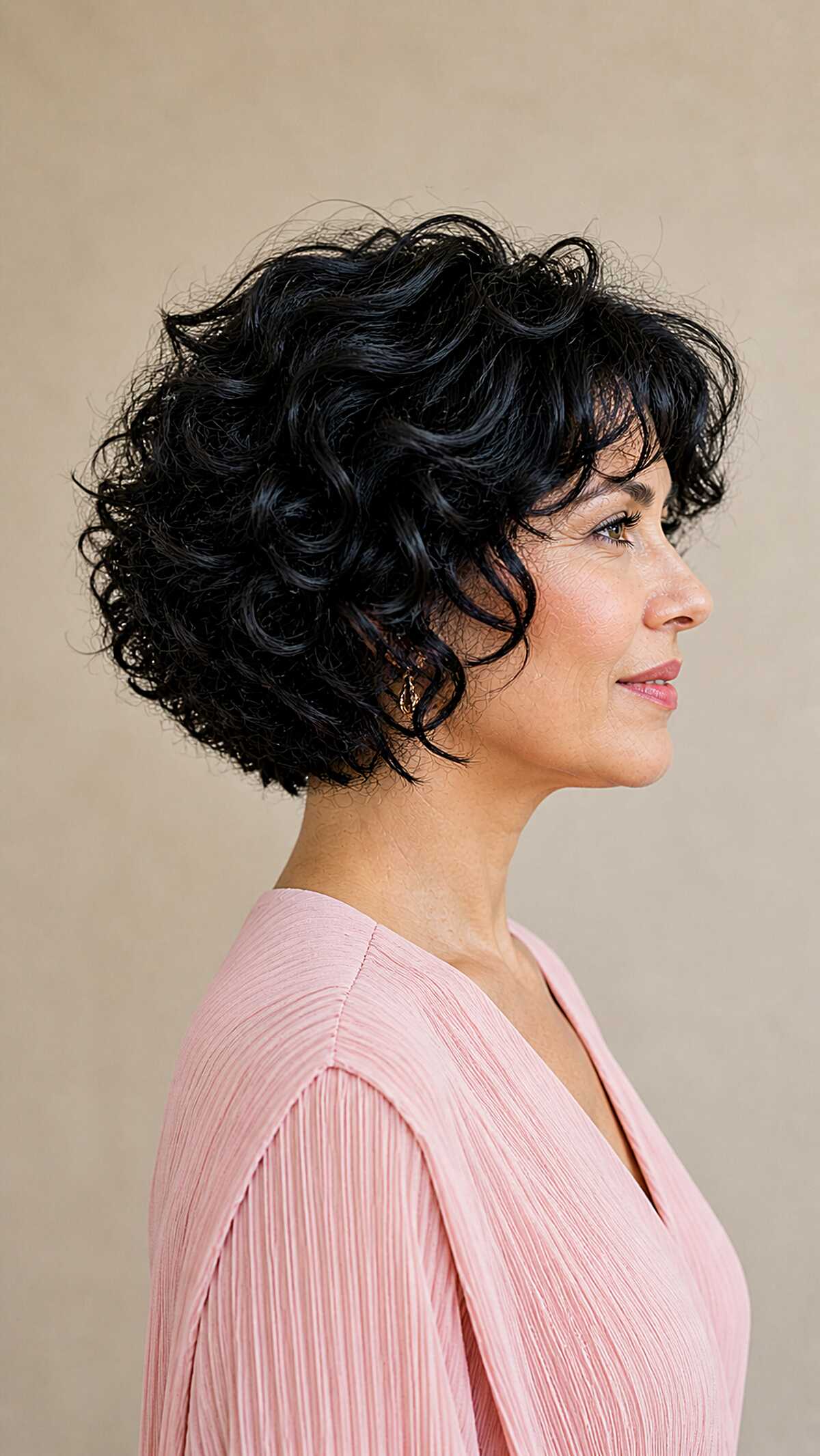 Jet black voluminous curly bob with soft layers