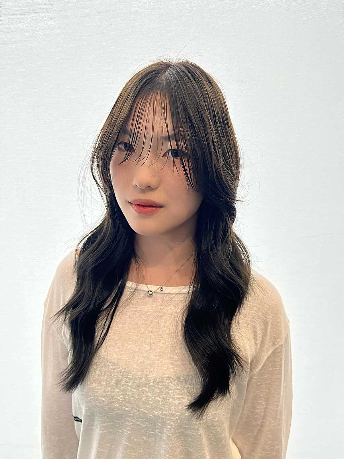 Long Dark Hair with Wispy Layers and Curtain Bangs