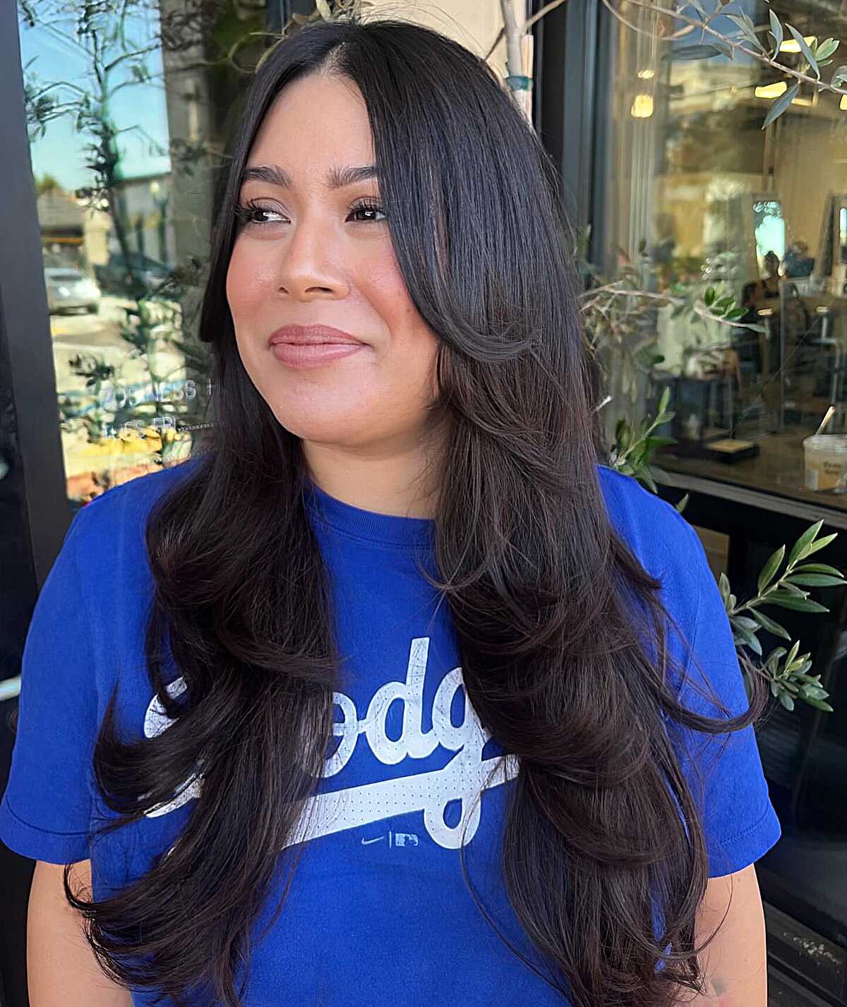 Long dark brown layered hair with subtle curtain bangs