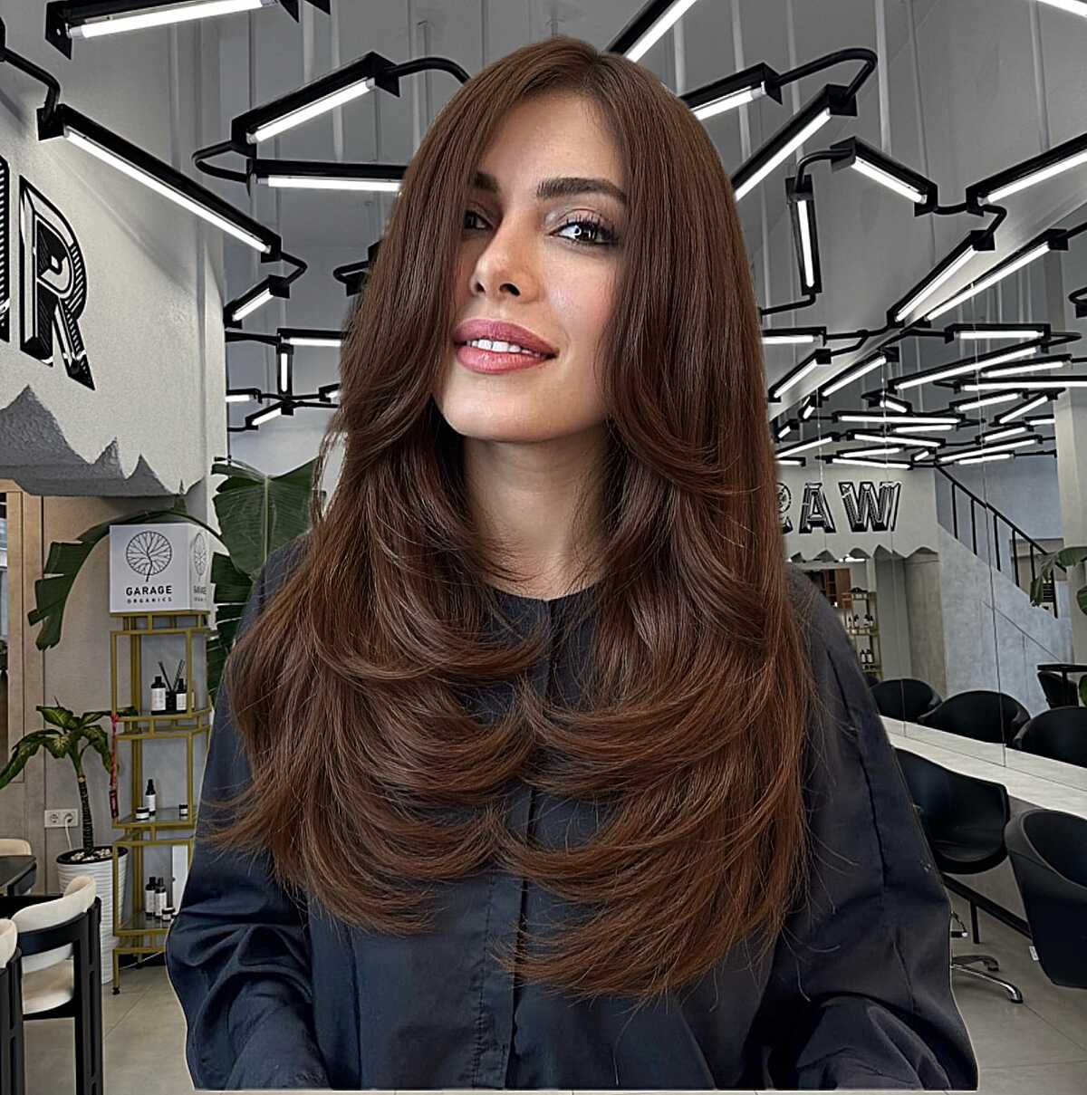 Warm chestnut long layered blowout with curtain bangs