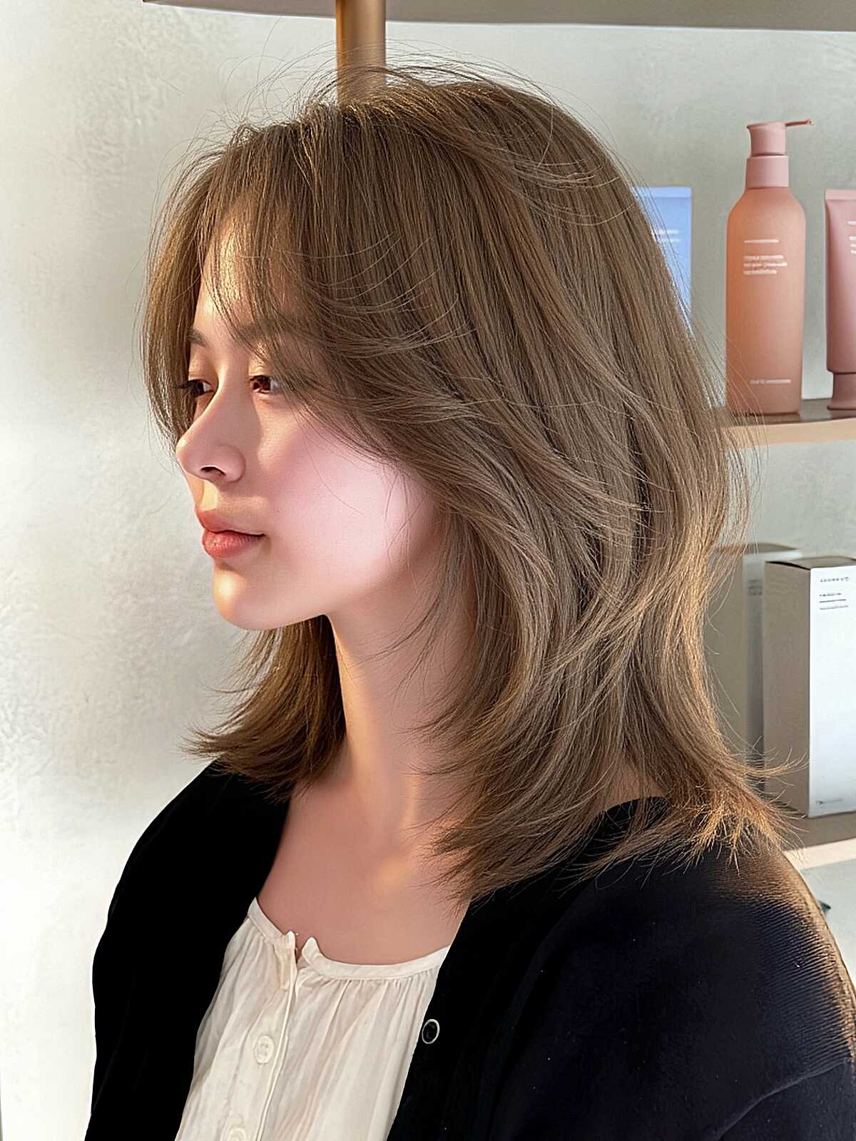 Ash brown layered lob with wispy fringe on thick hair