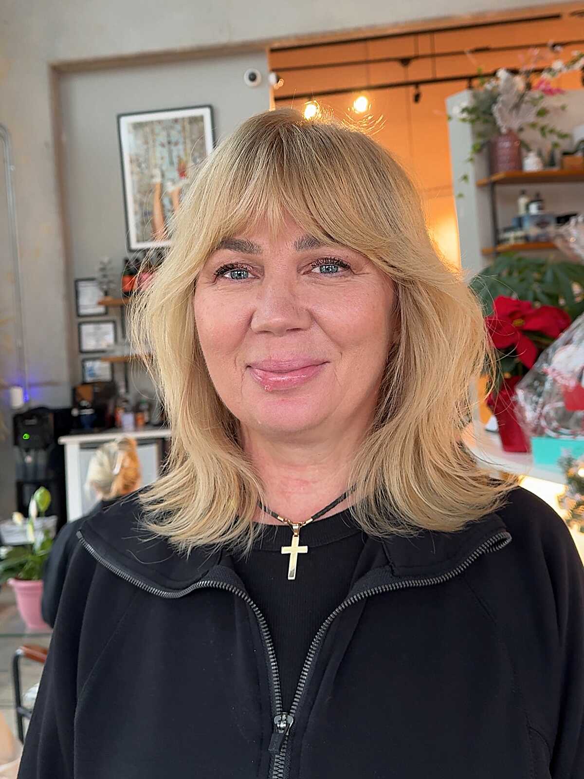 Blonde feathered lob with full bangs on thick hair