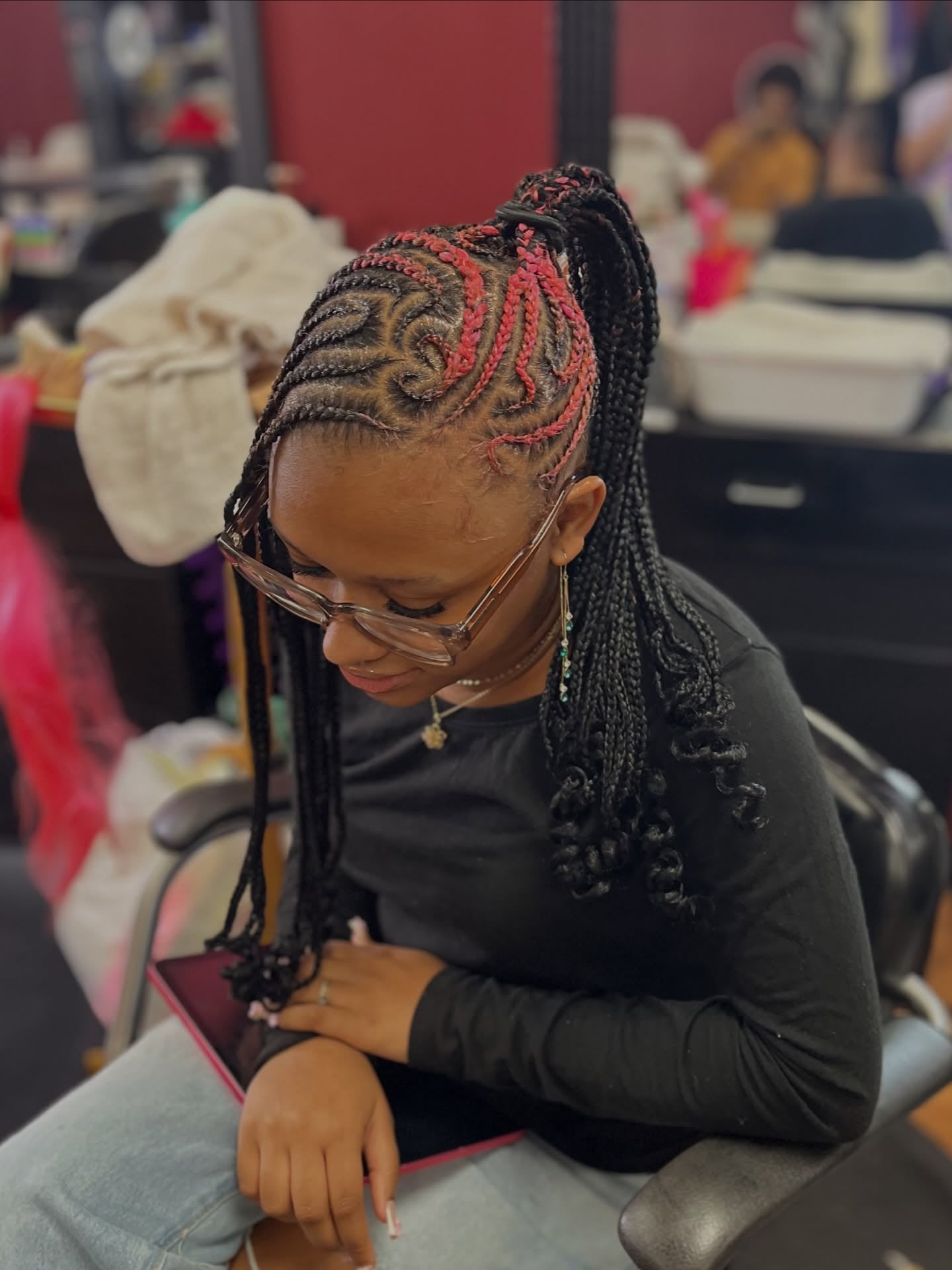 Cornrow Ponytail with Red Accent Braids and Curly Ends