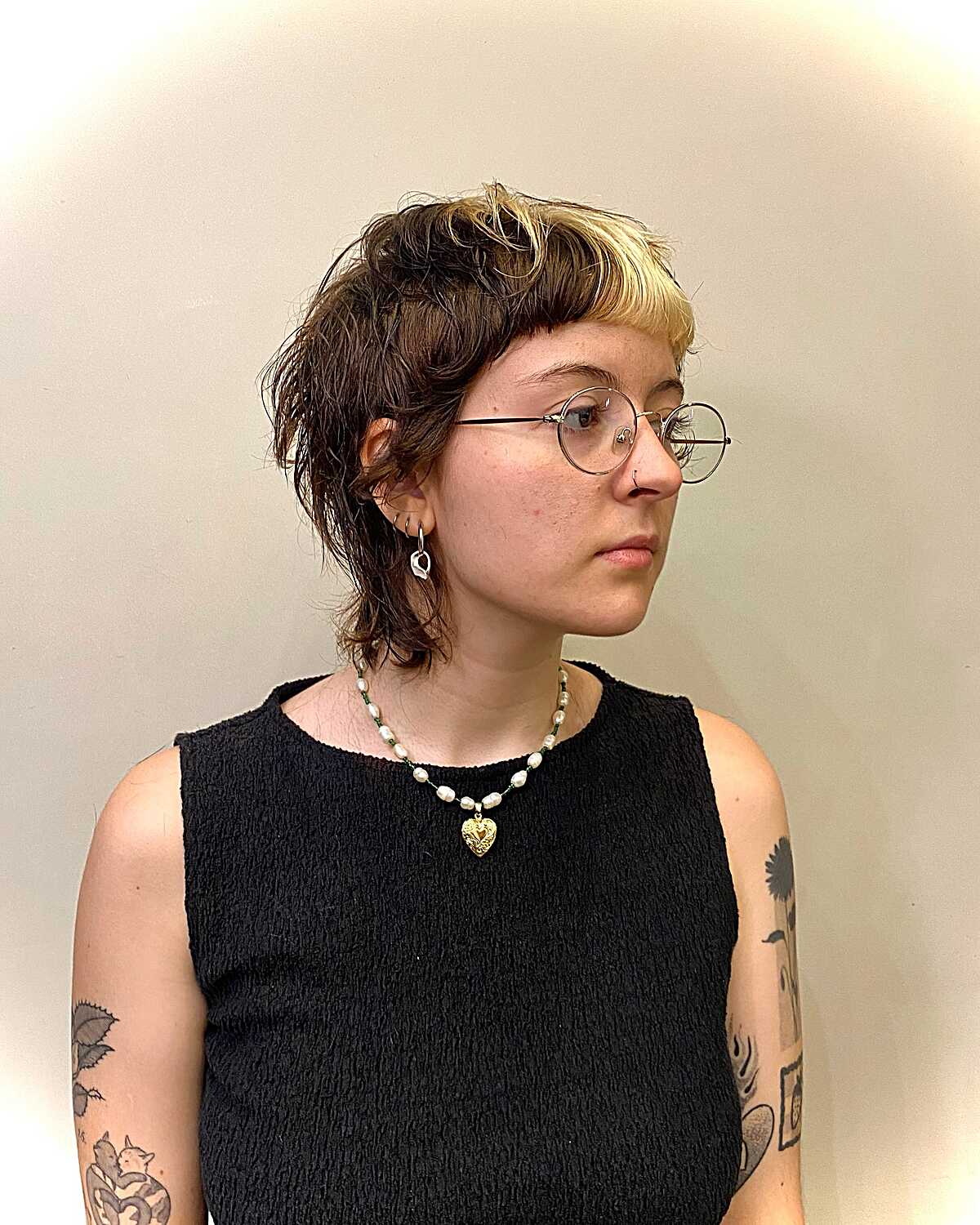 Wavy mullet pixie with blonde bangs and dark lengths
