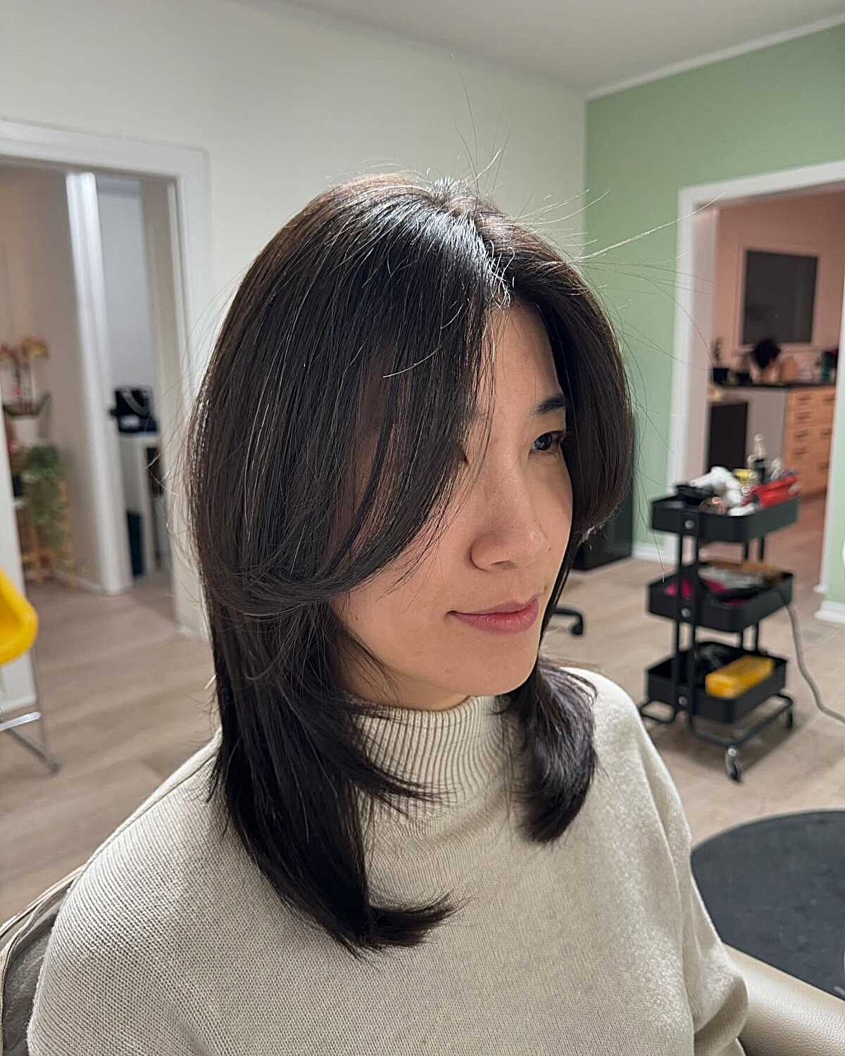 Straight dark mid length cut with face-framing layers