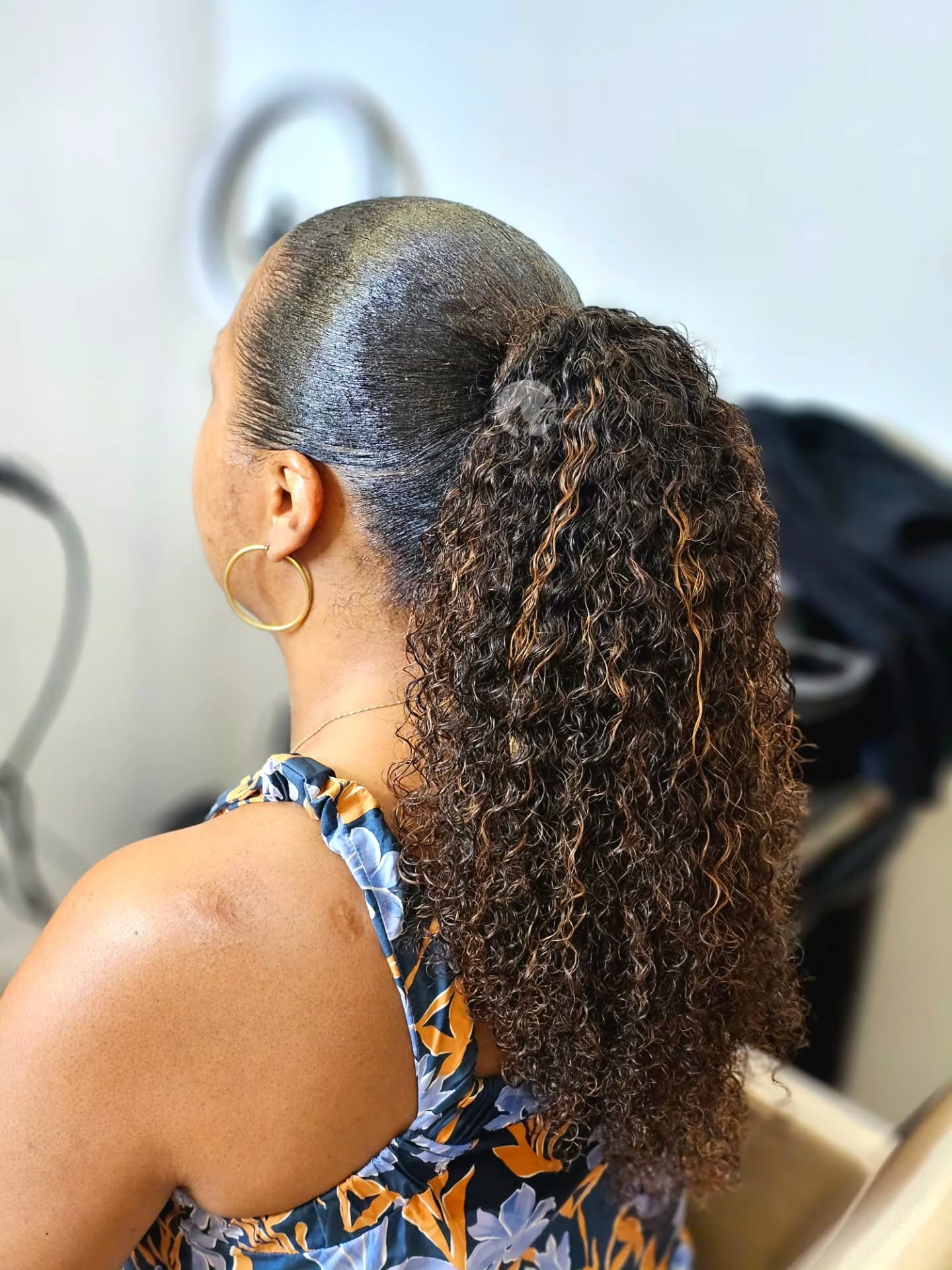 High Curly Ponytail with Honey Brown Highlights