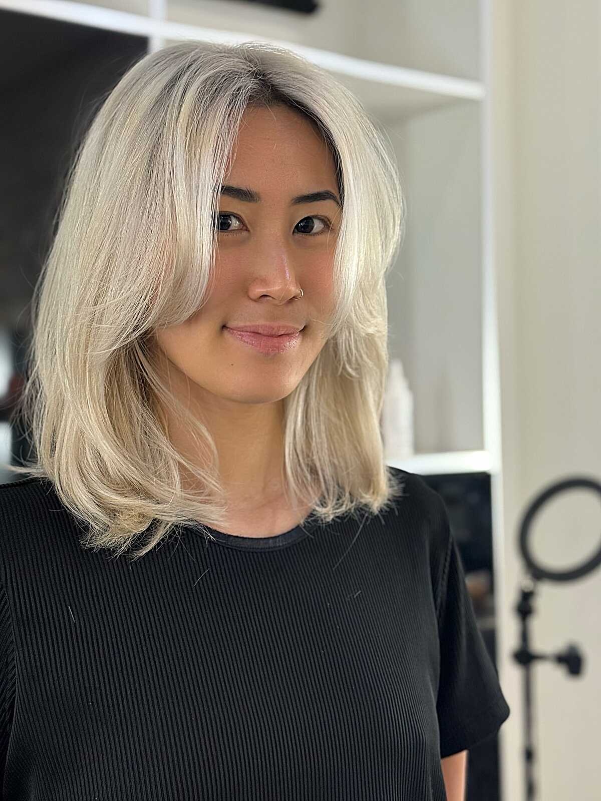 Platinum blonde mid length cut with soft lived-in wave