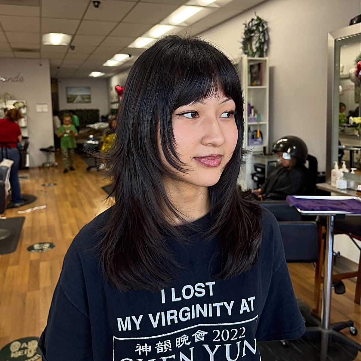 Jet black mid length shag with wispy bangs and layers