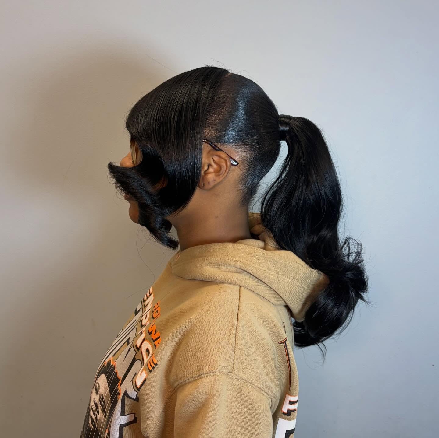 Low Ponytail with Curled Layers and Deep Side Part