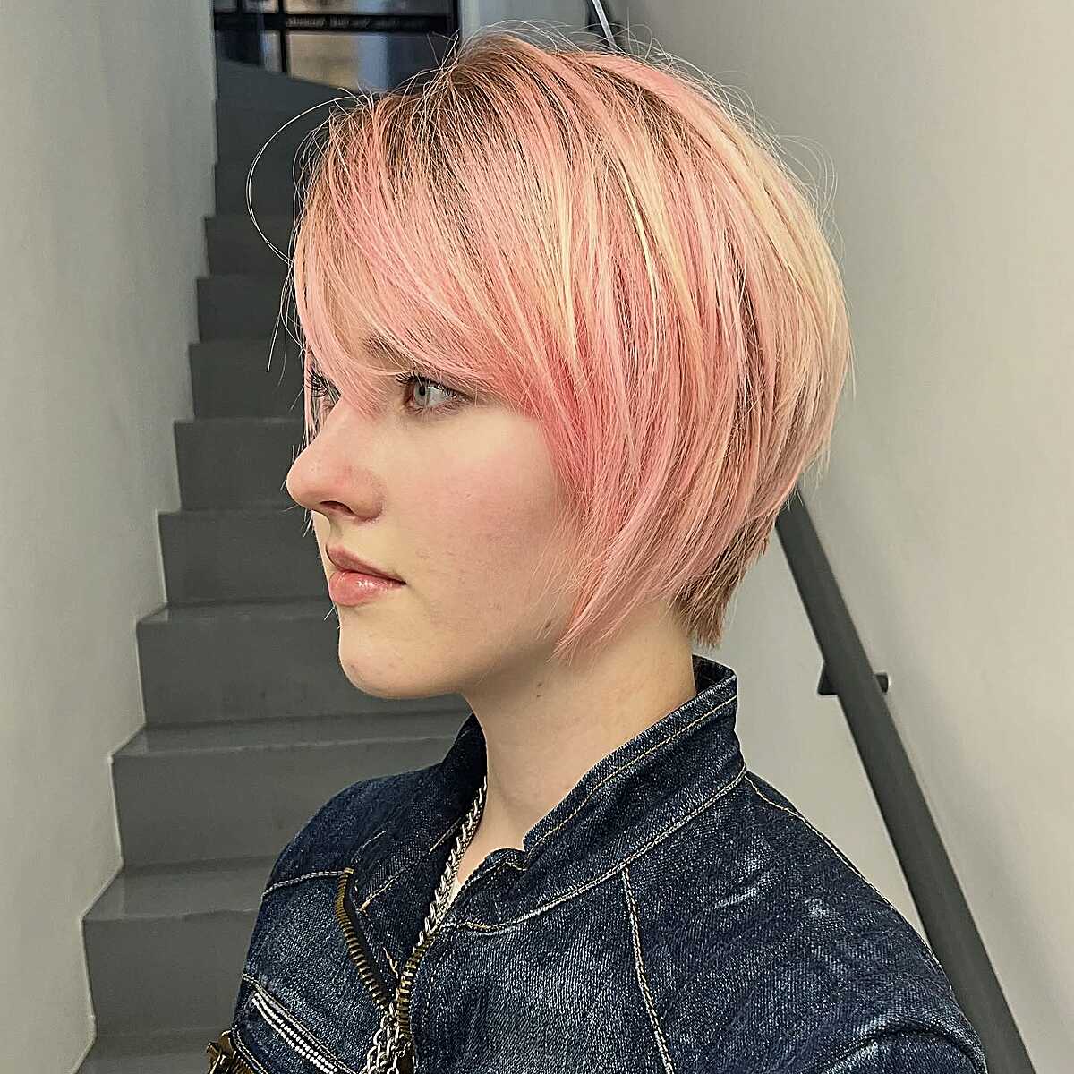 Pastel pink and blonde pixie bob with straight bangs