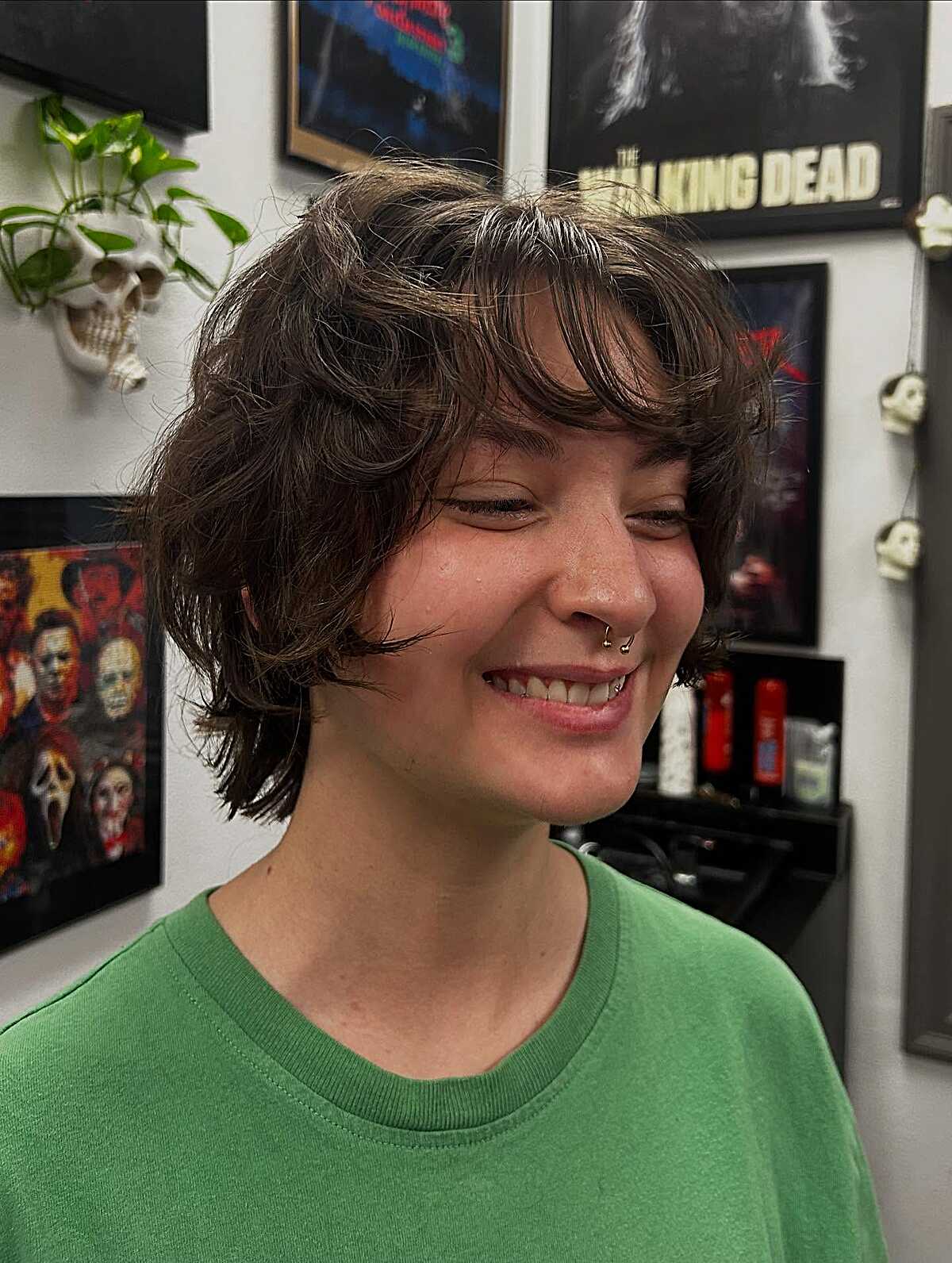 Shaggy brunette wavy pixie with wispy layers