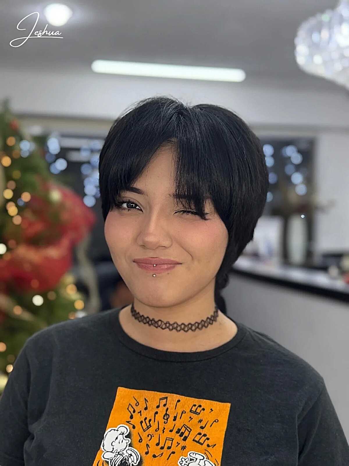Sleek black pixie with full bangs and rounded shape