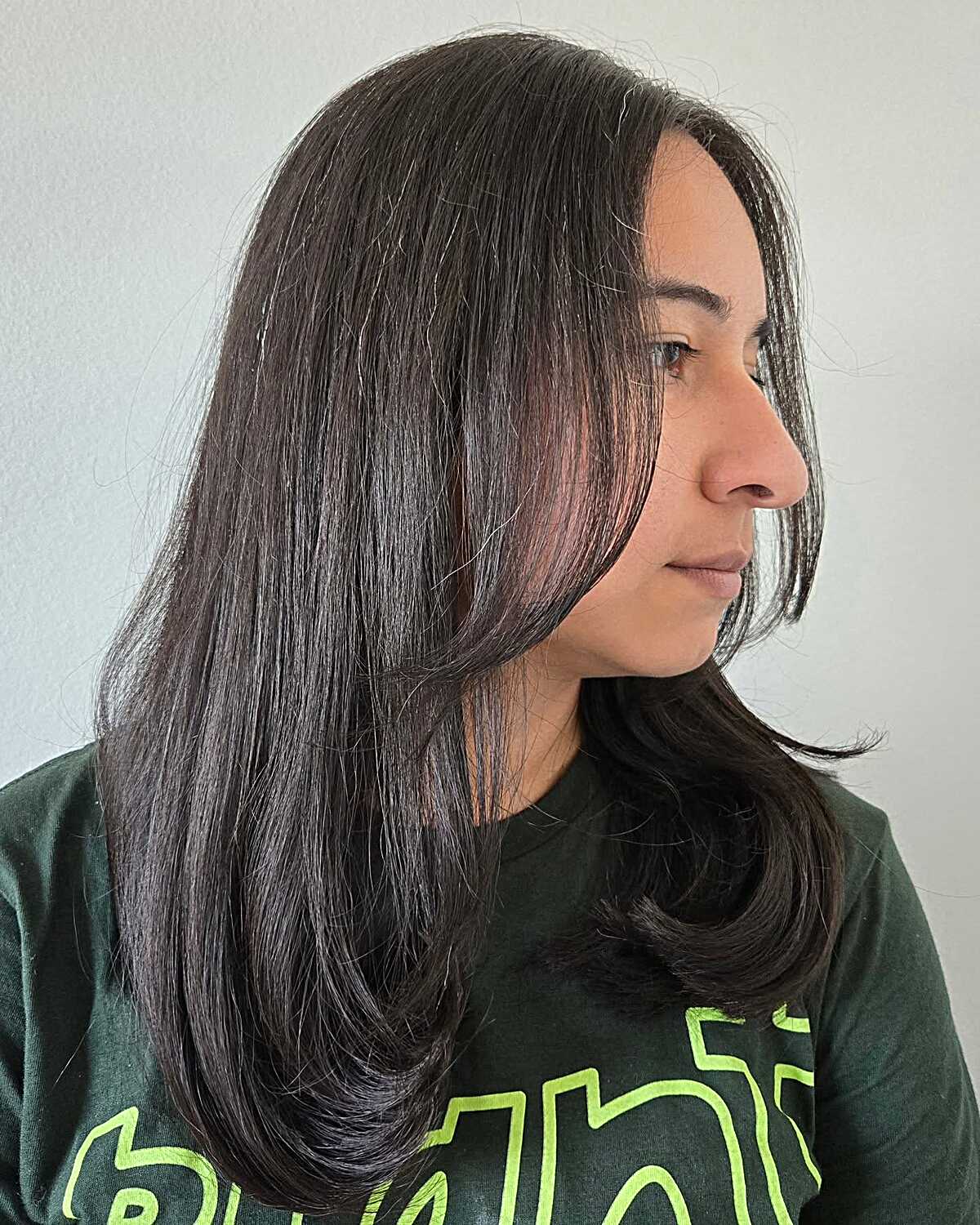 Sleek dark brown mid length layers with a subtle flip