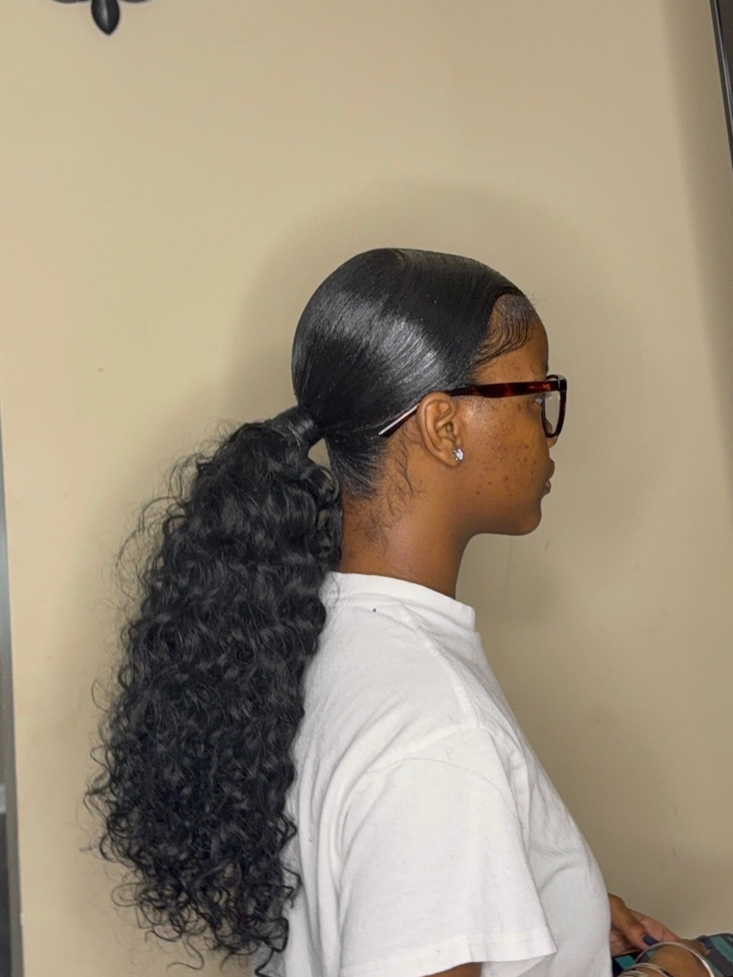 Slicked Low Ponytail with Deep Wave Curly Texture