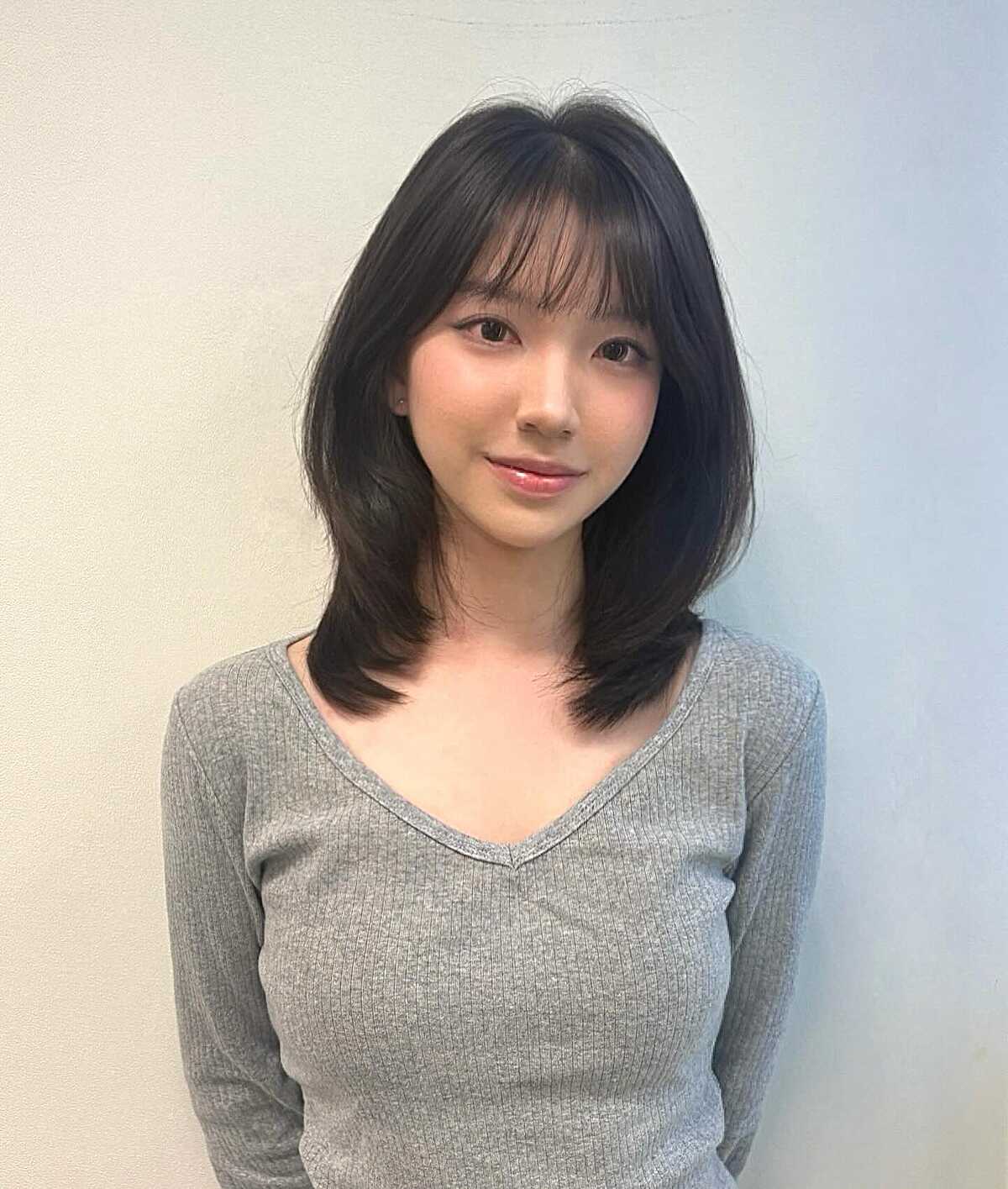 Soft black mid length layers with see-through bangs