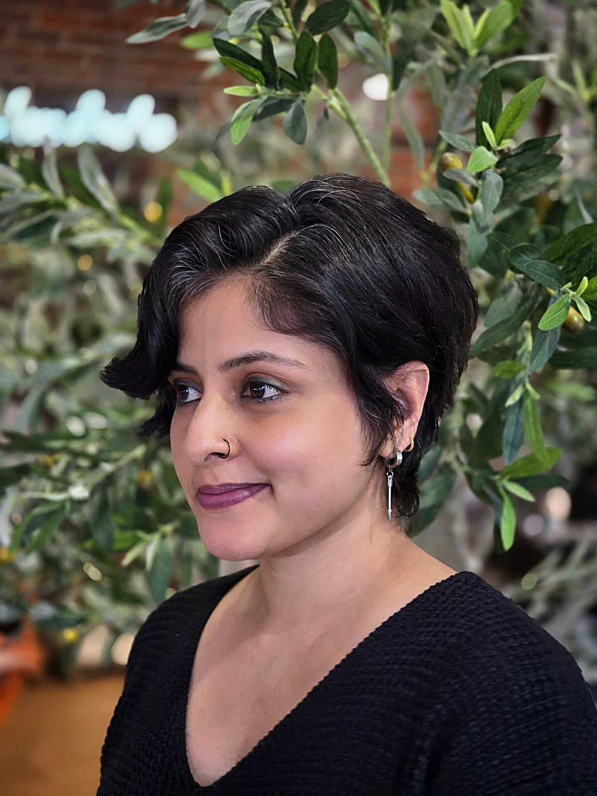 Soft black side-swept pixie with gentle wave pattern