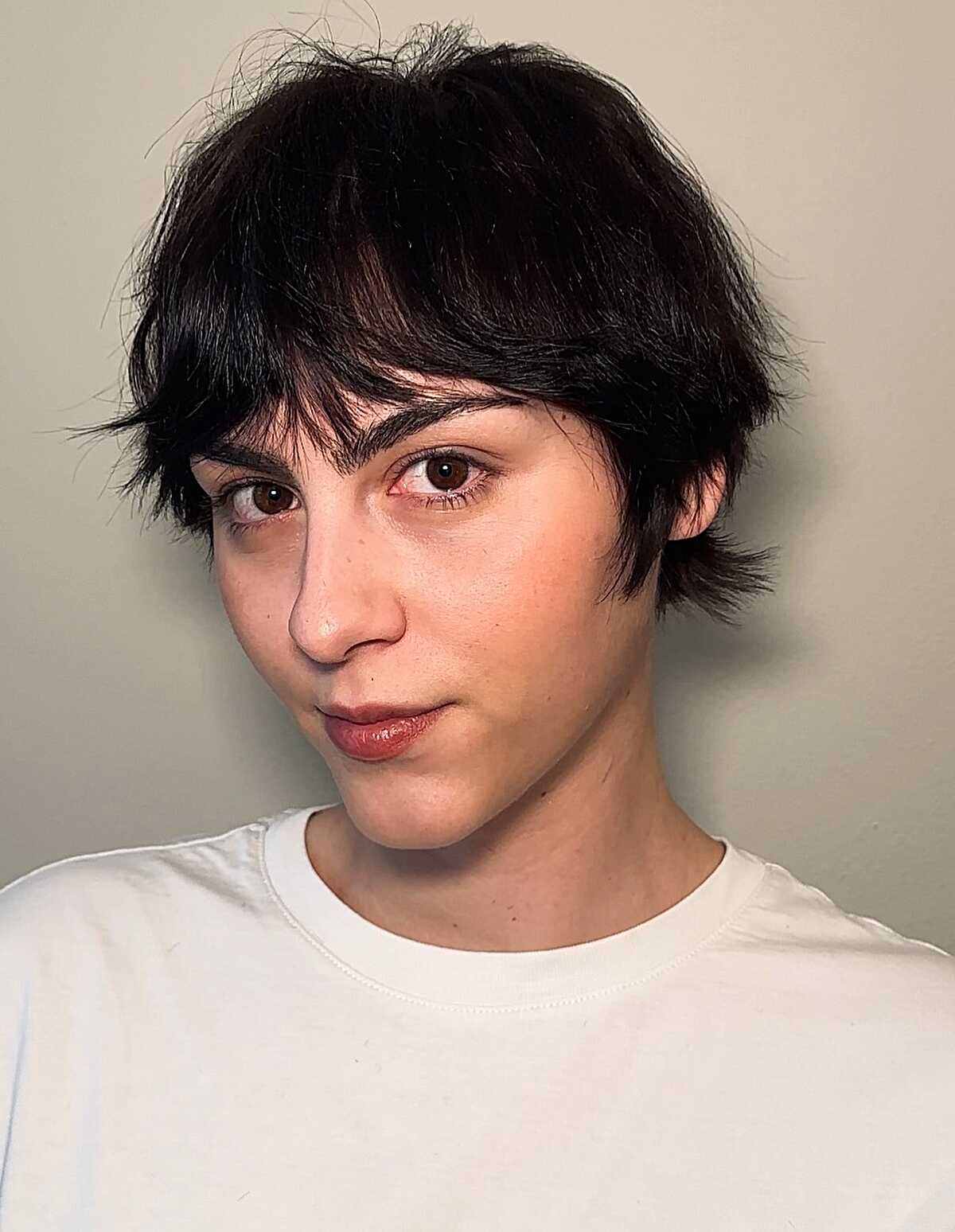 Tousled dark brown fluffy pixie with soft fringe