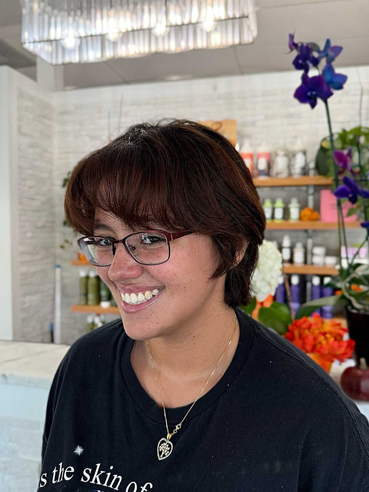 Warm-toned brown fluffy pixie cut with full bangs