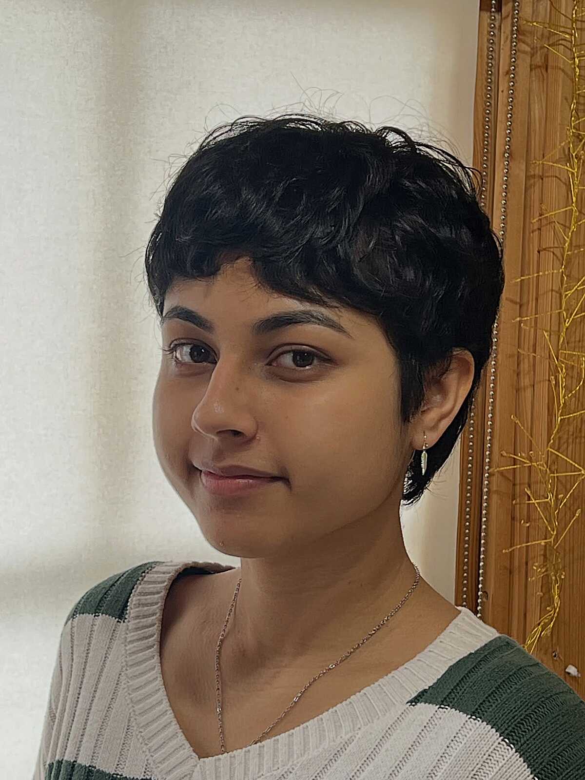 Short black wavy pixie with natural soft curls