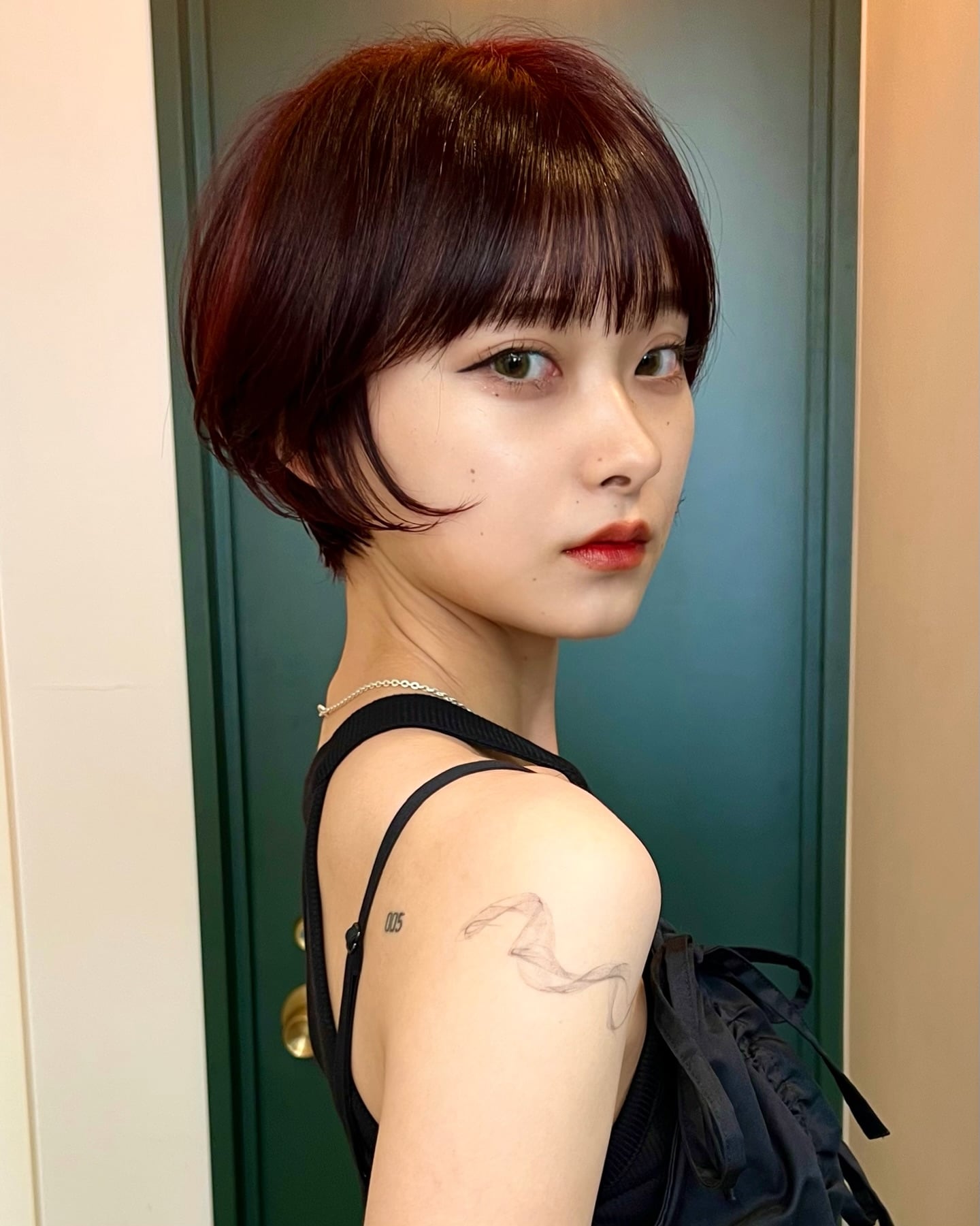 Short burgundy red bowl cut with micro bangs