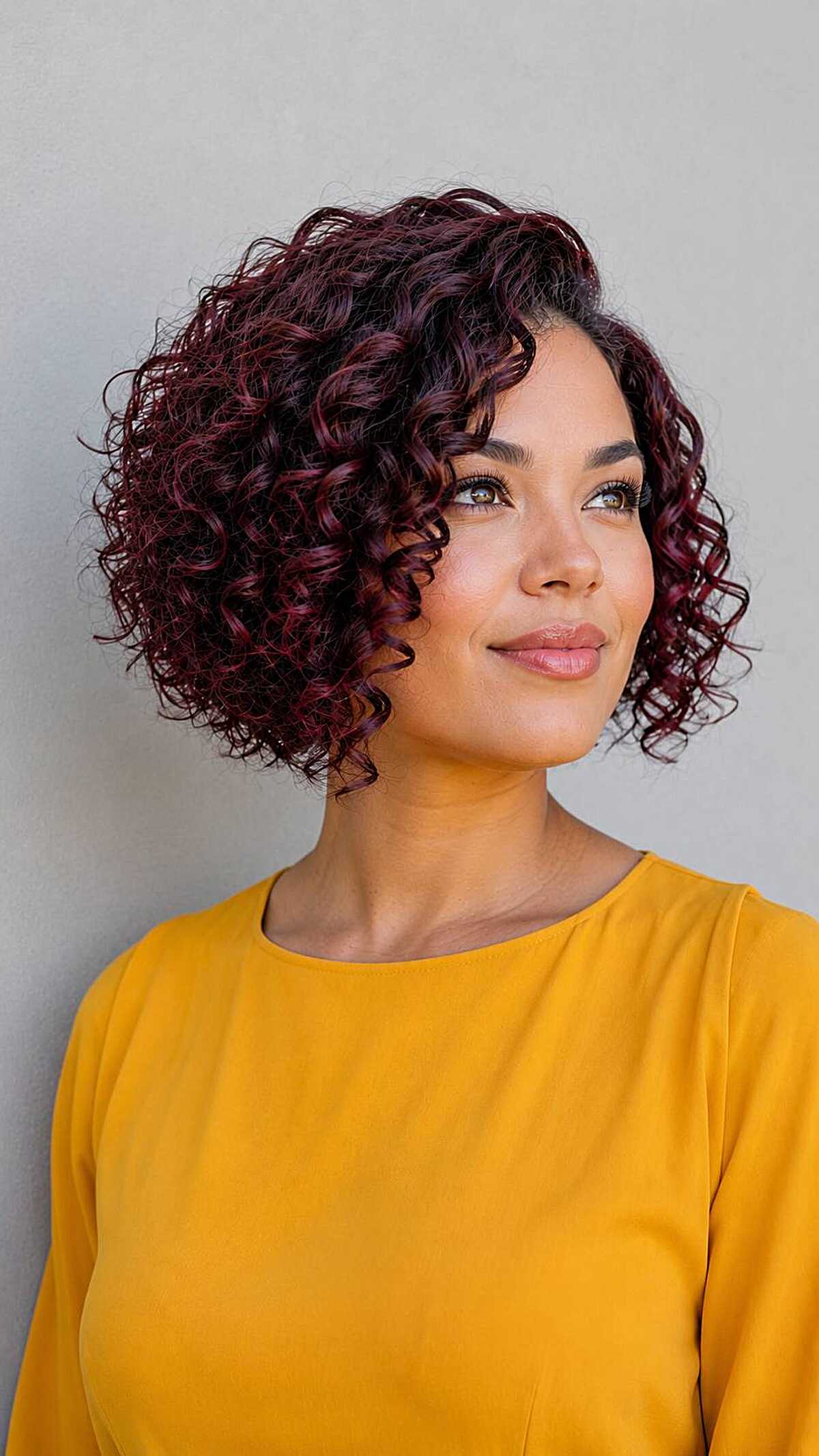 Deep burgundy curly inverted bob with tight spirals