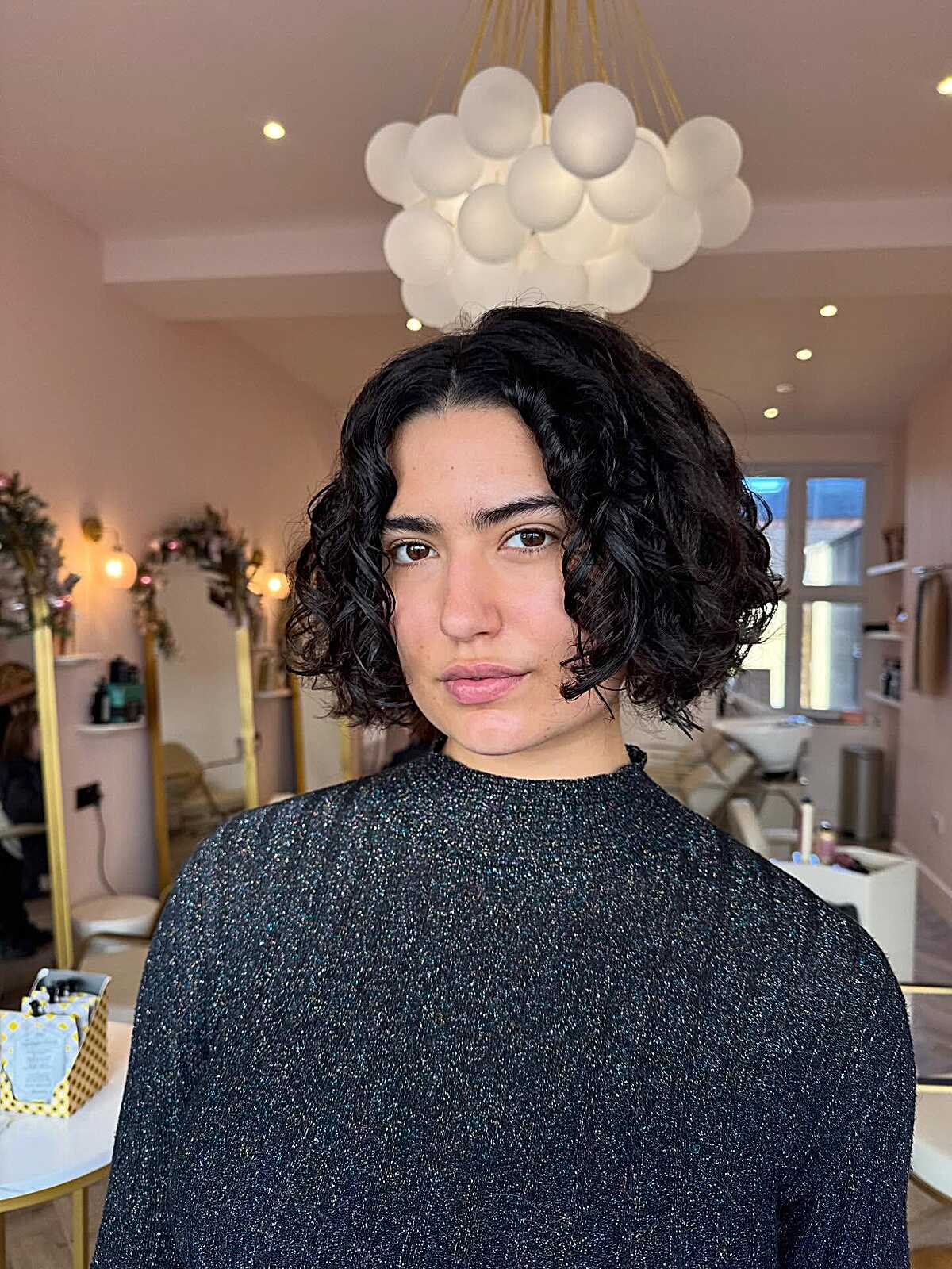 Chin-Length Dark Curly Bob with Deep Side Part