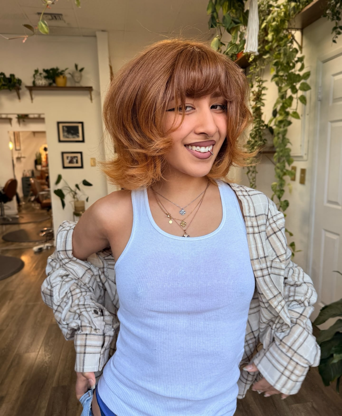 Copper penny toned bob with full bangs and wavy texture