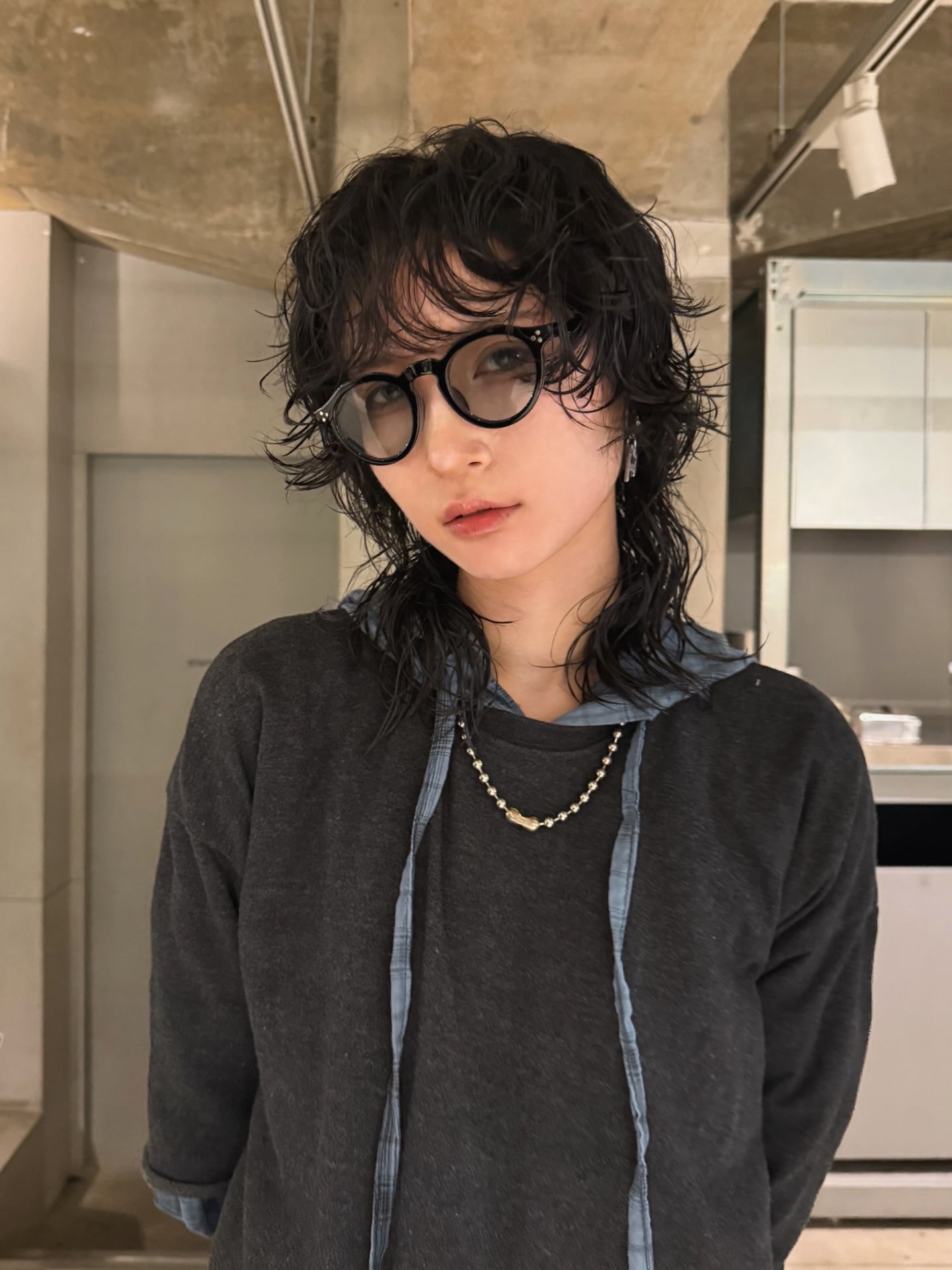 Short curly dark shag mullet with messy bangs