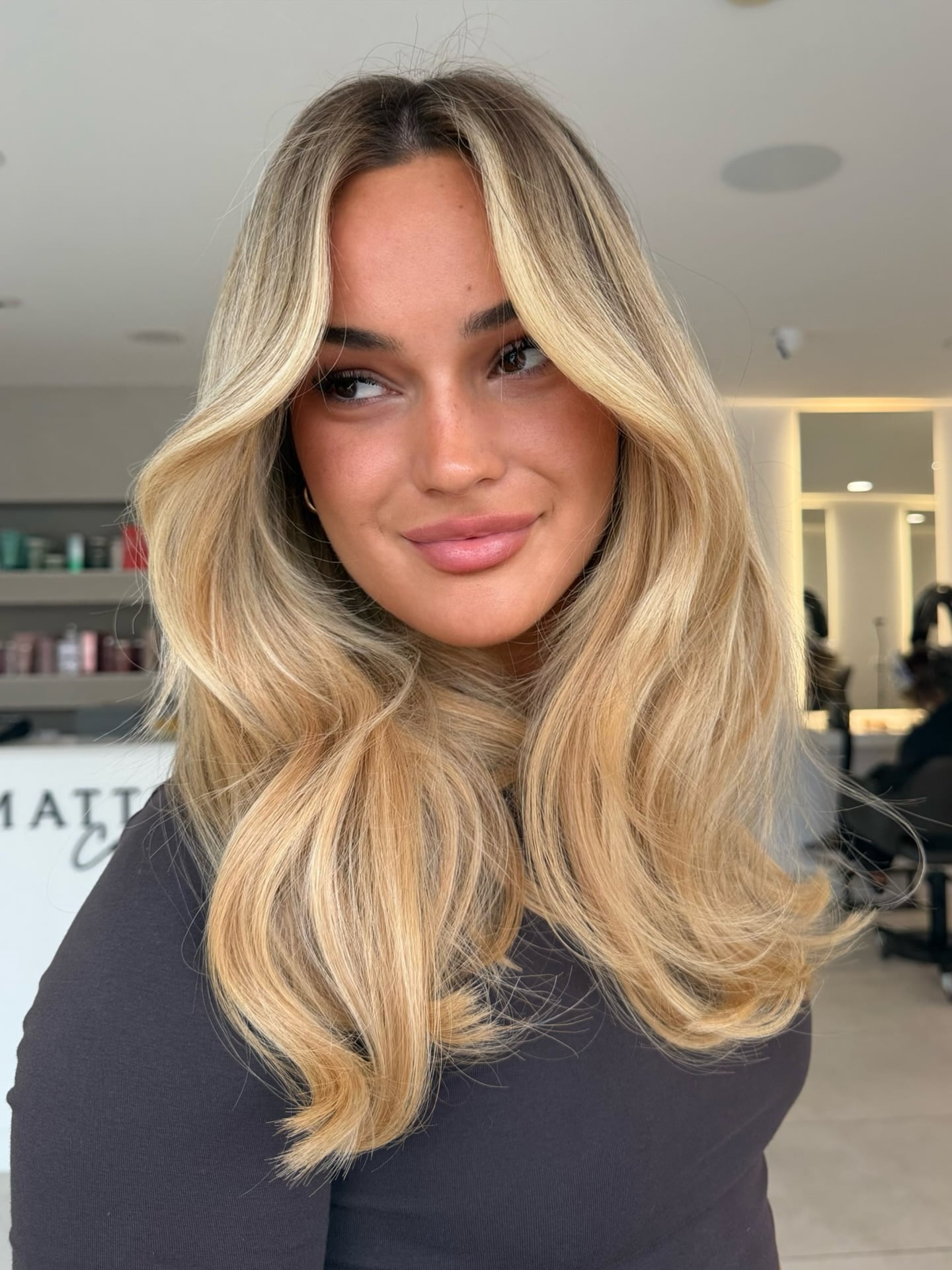 Golden blonde long hair with curtain bangs and soft waves