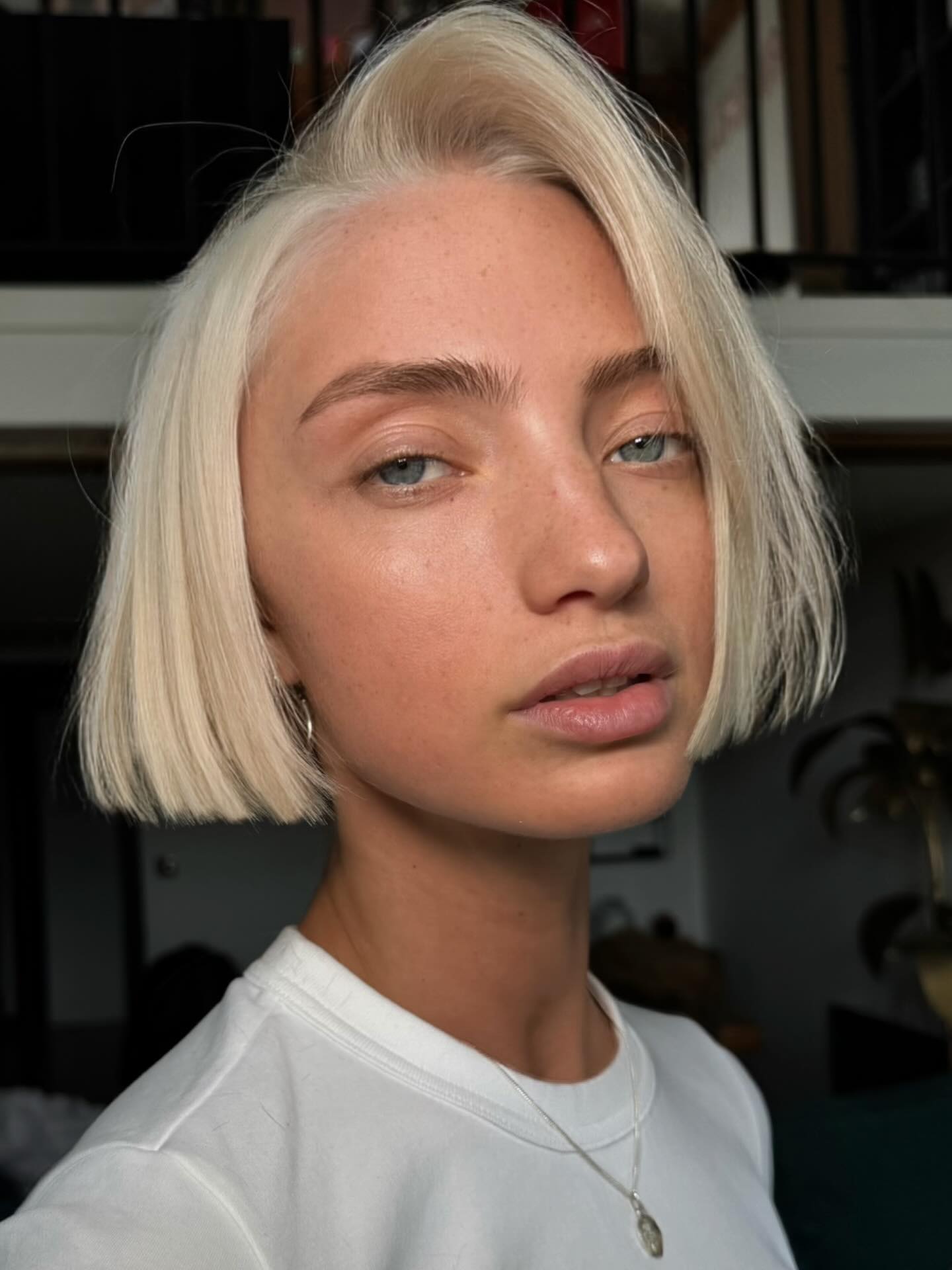 Platinum blonde blunt chin-length bob with middle part