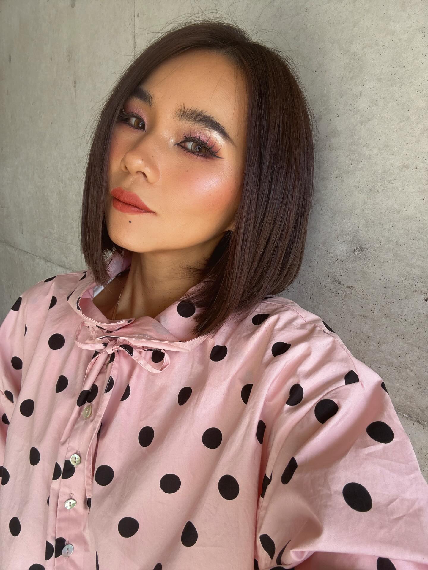 Sleek dark brunette chin-length bob with center part