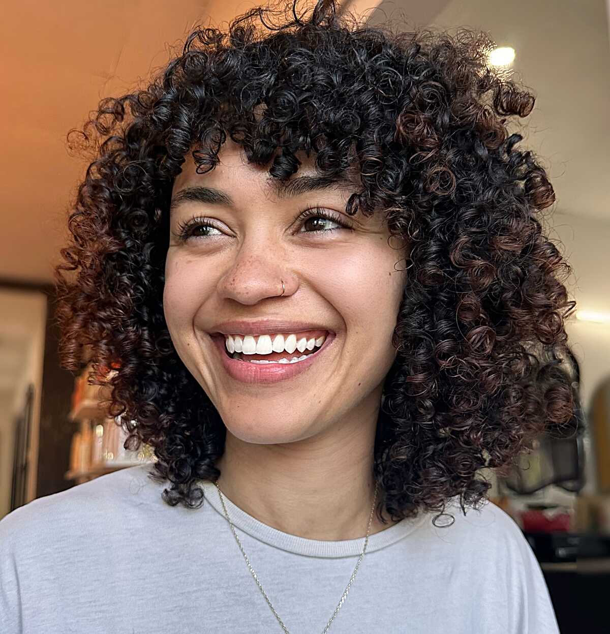 Chin-Length Tight Curls with Warm Brown Highlights