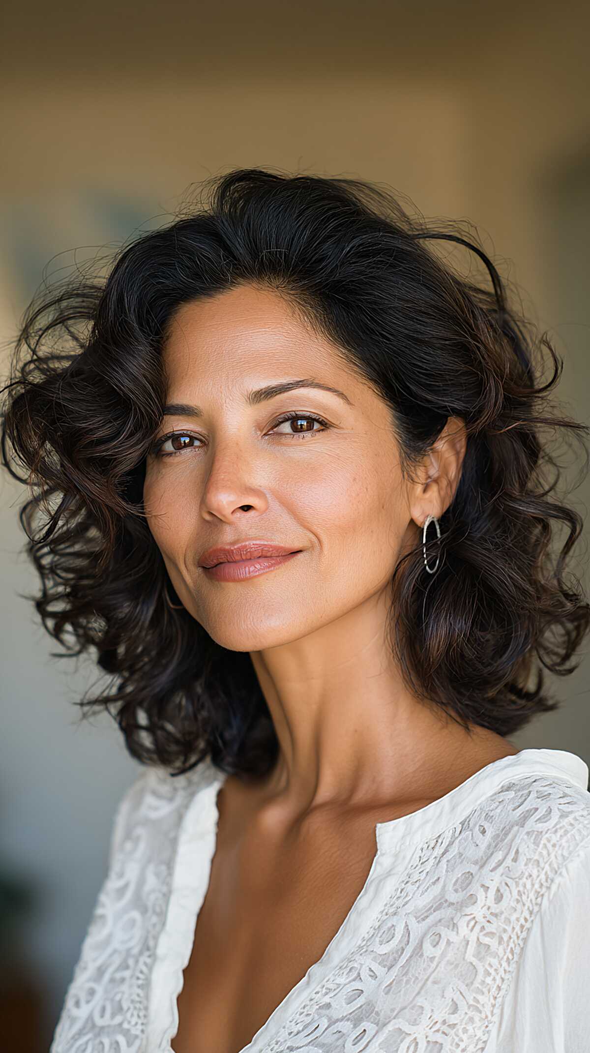 Voluminous dark curly shoulder-length cut with body
