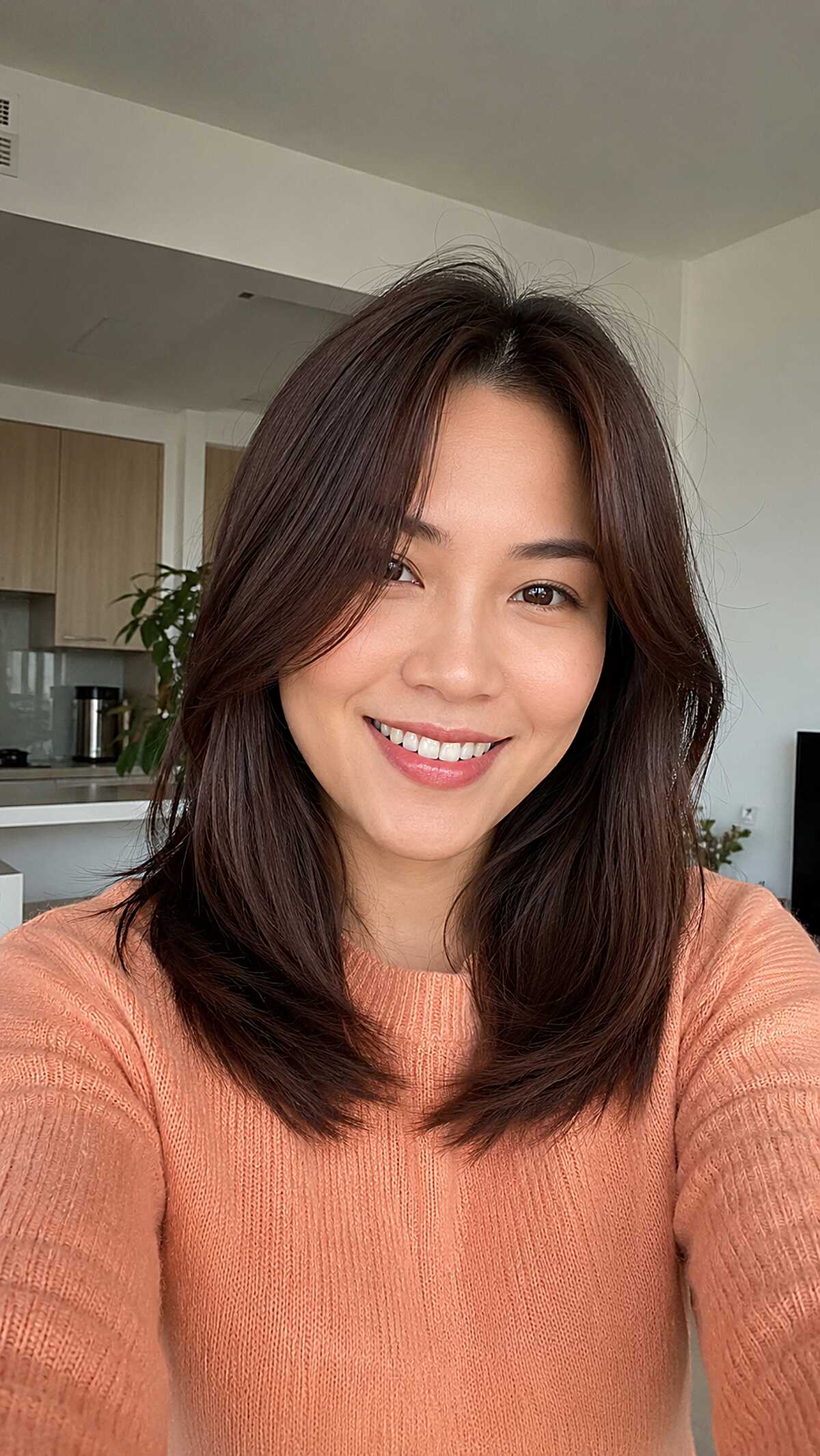 Chocolate brown mid-length hair with curtain bangs