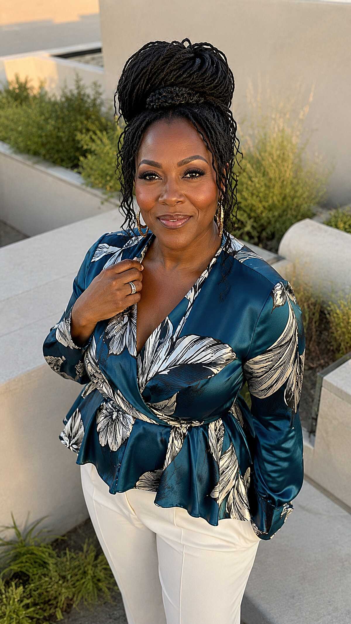 Stacked High Bun with Face-Framing Loc Tendrils